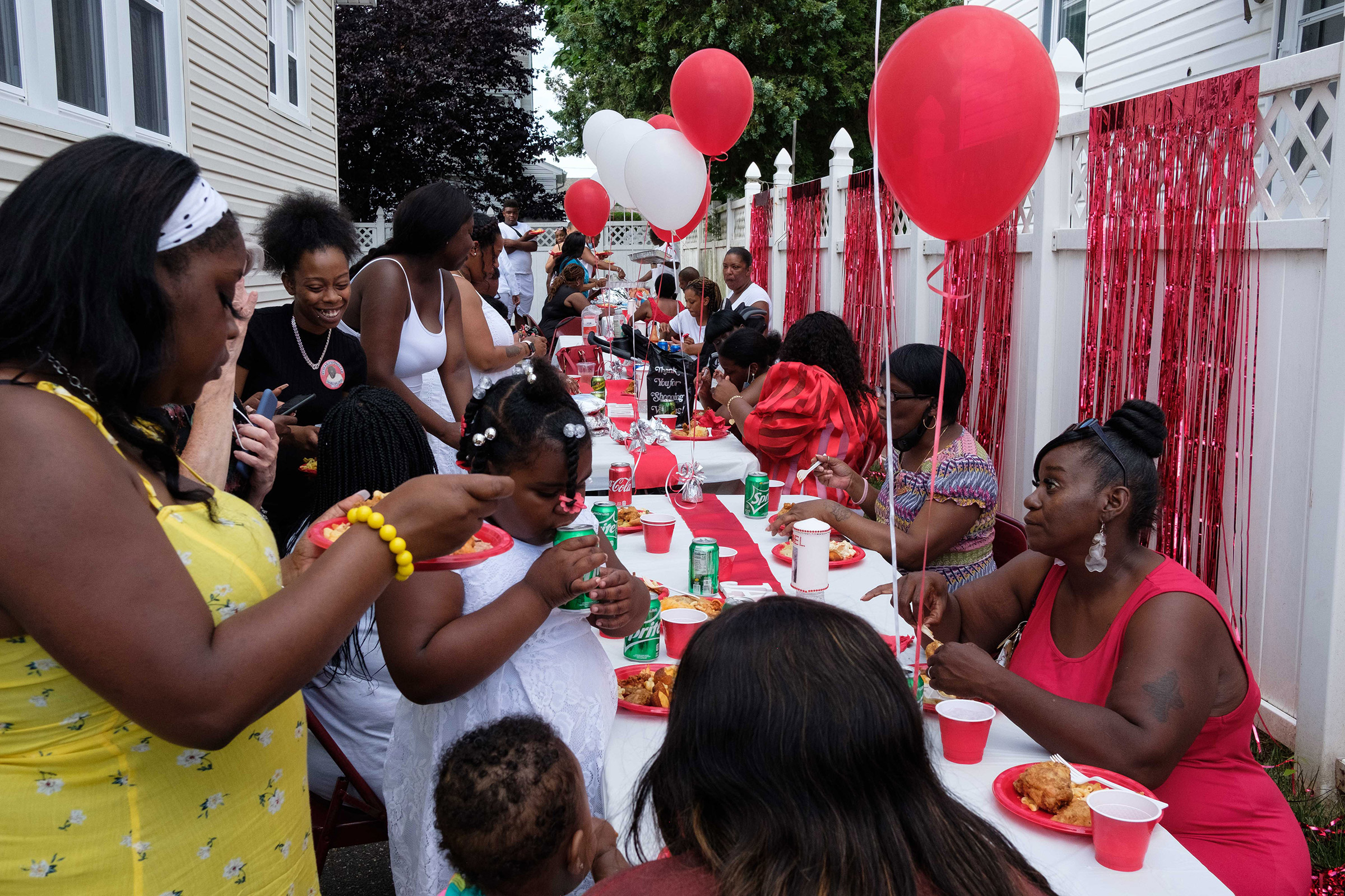 Family members gather for dinner at Jamel Floyd’s house after the funeral and burial. (Yuki Iwamura)