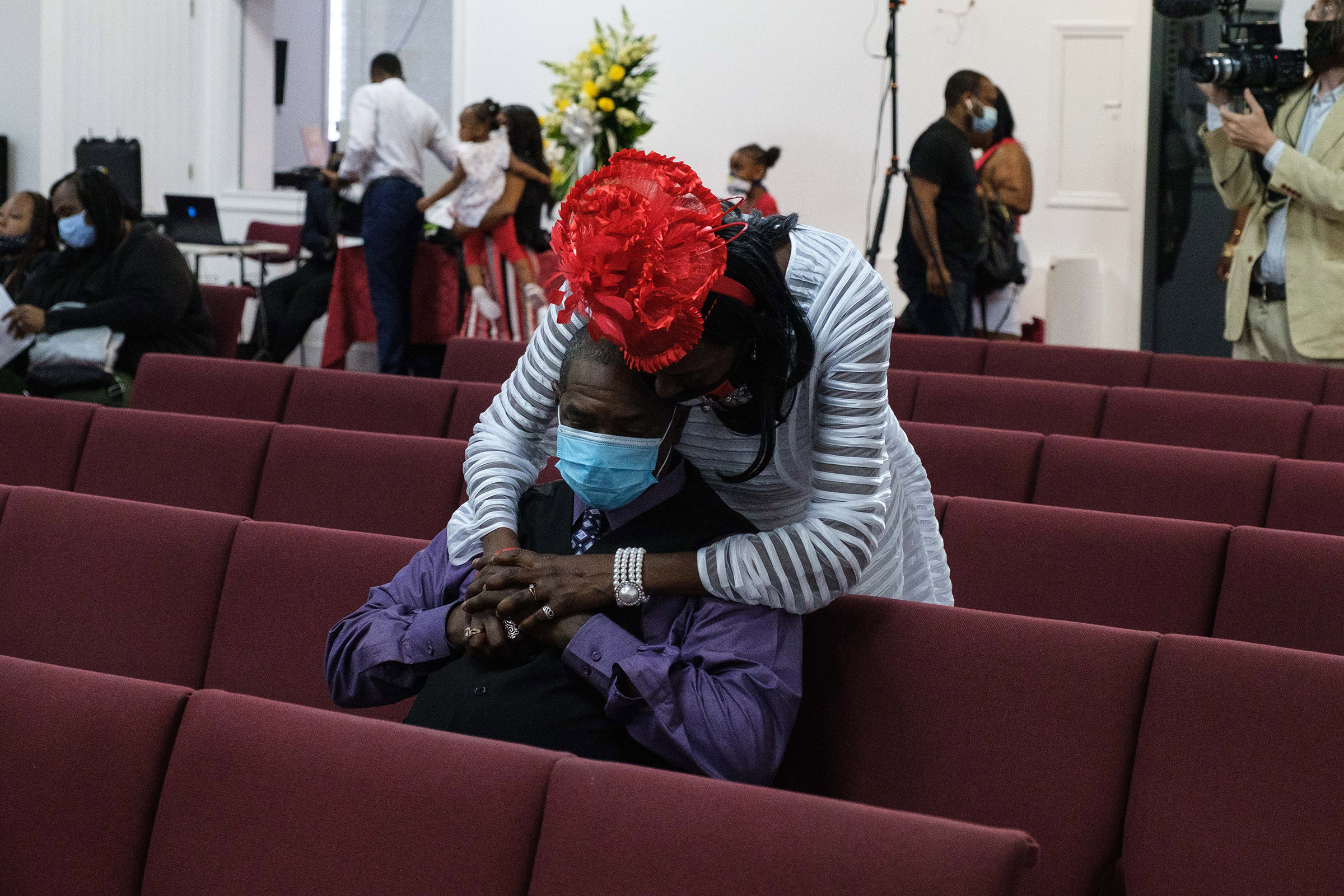 Donna Mays hugs Jamel Floyd's cousin, Mark Lumpkin, during the funeral on June 30.