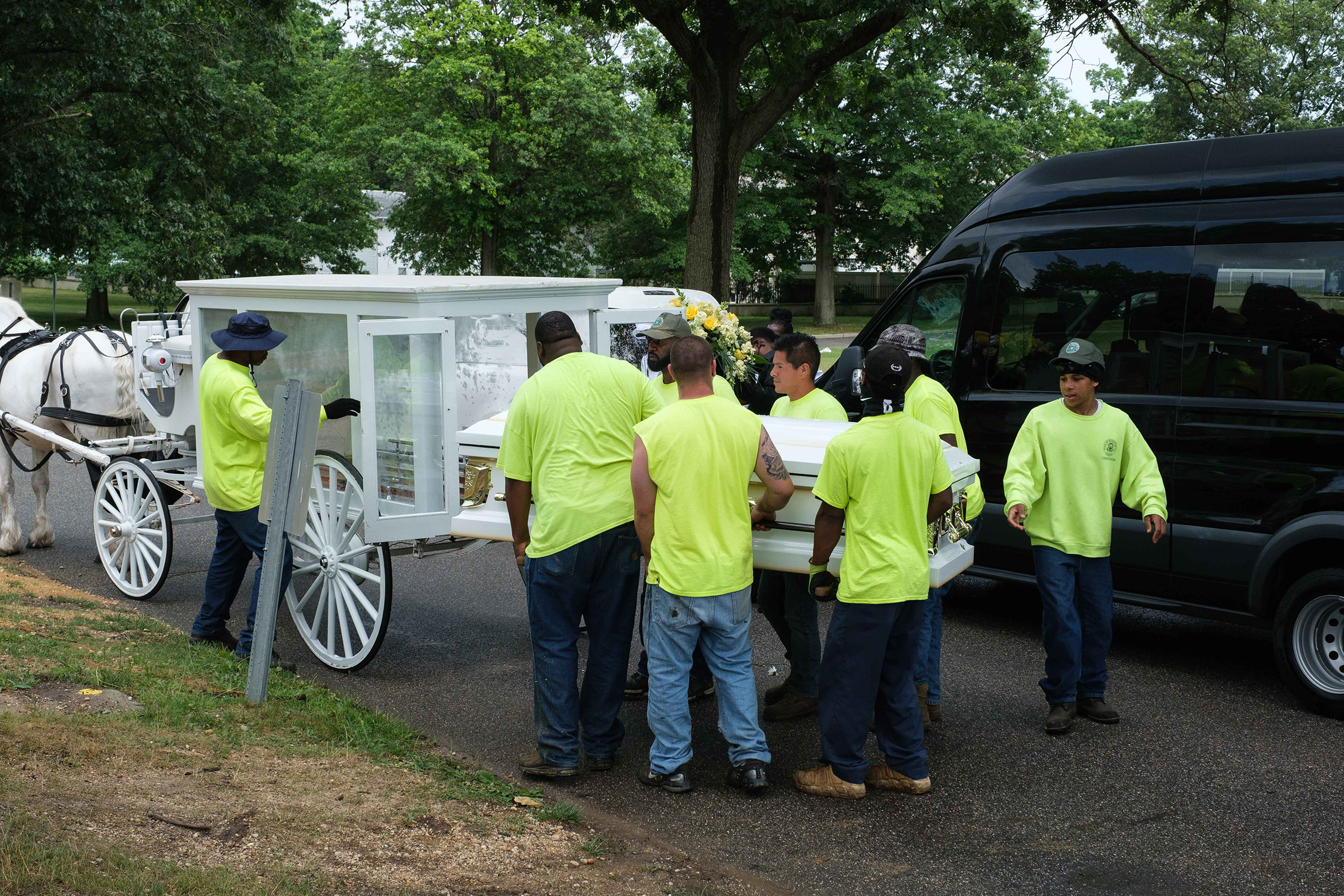 Cemetery workers carry Jamel Floyd’s coffin to the burial site at Greenfield Cemetery in Hempstead, N.Y., on June 30.