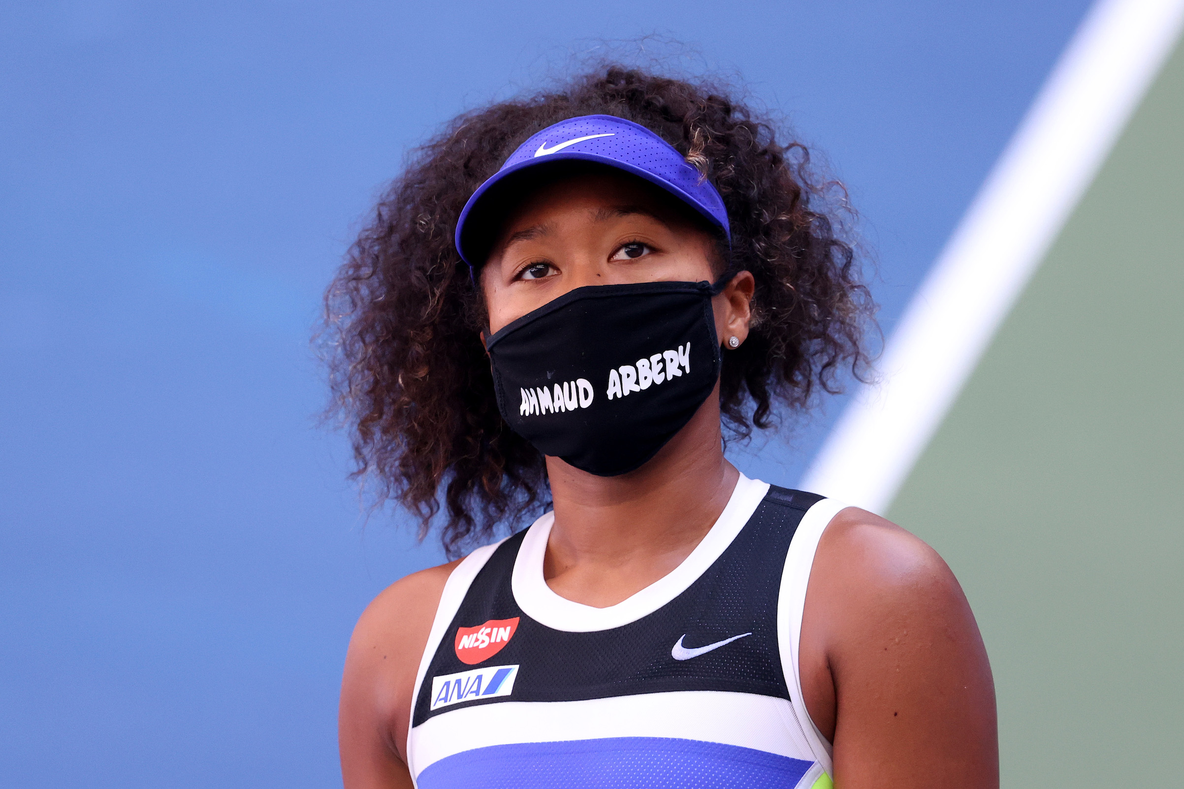 Naomi Osaka of Japan wears a protective face mask with the name Ahmaud Arbery stenciled on it after winning her Women's Singles third round match on Day Five of the 2020 U.S. Open in New York City. (Al Bello—Getty Images)