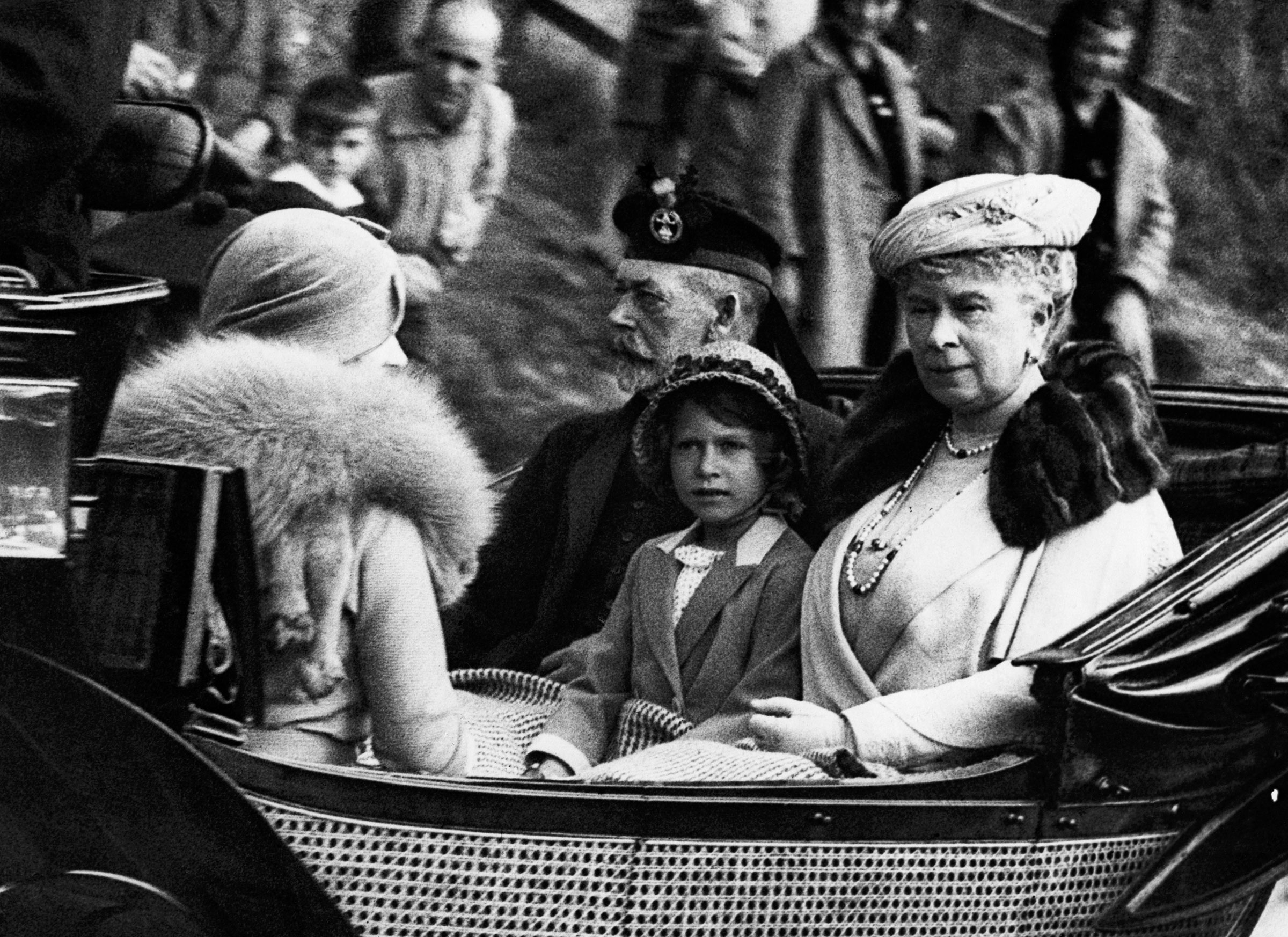 Princess Elizabeth sits between her grandparents, King George V and Queen Mary of England, facing her mother Elizabeth, the Duchess of York, as the Royal Family returns from a service at Crathie Church. (Hulton-Deutsch Collection/Corbis/Getty Images)