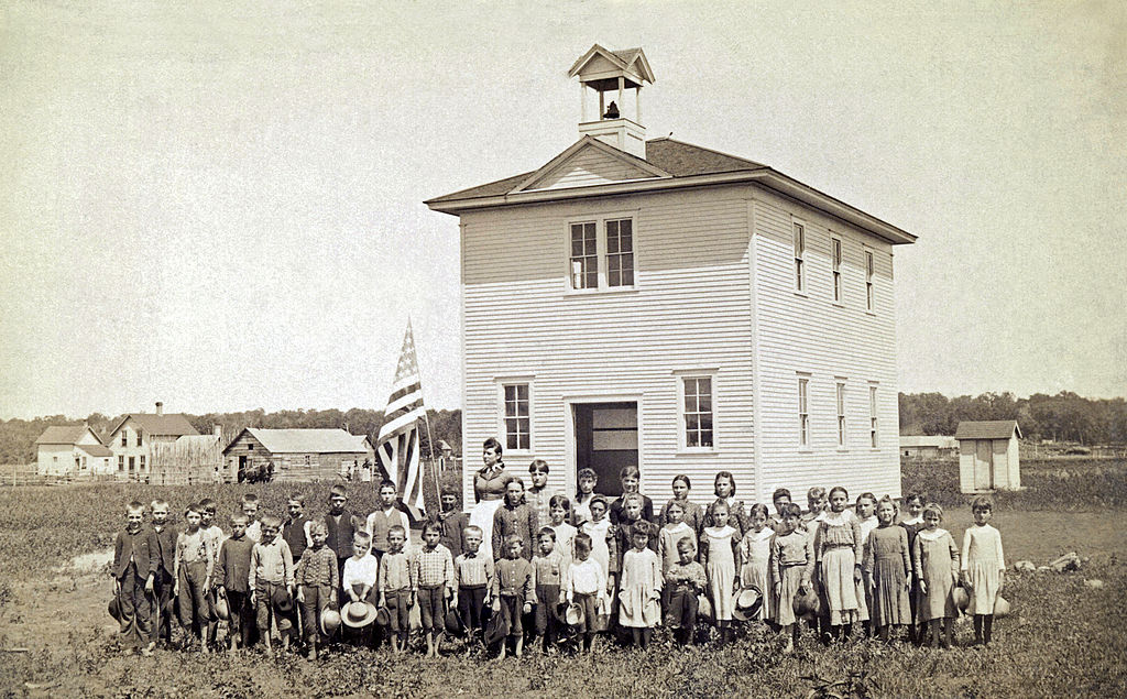 An American one room schoolhouse. with the class and teacher out front for their portrait, late 1880s or early 1890s (Getty Images)