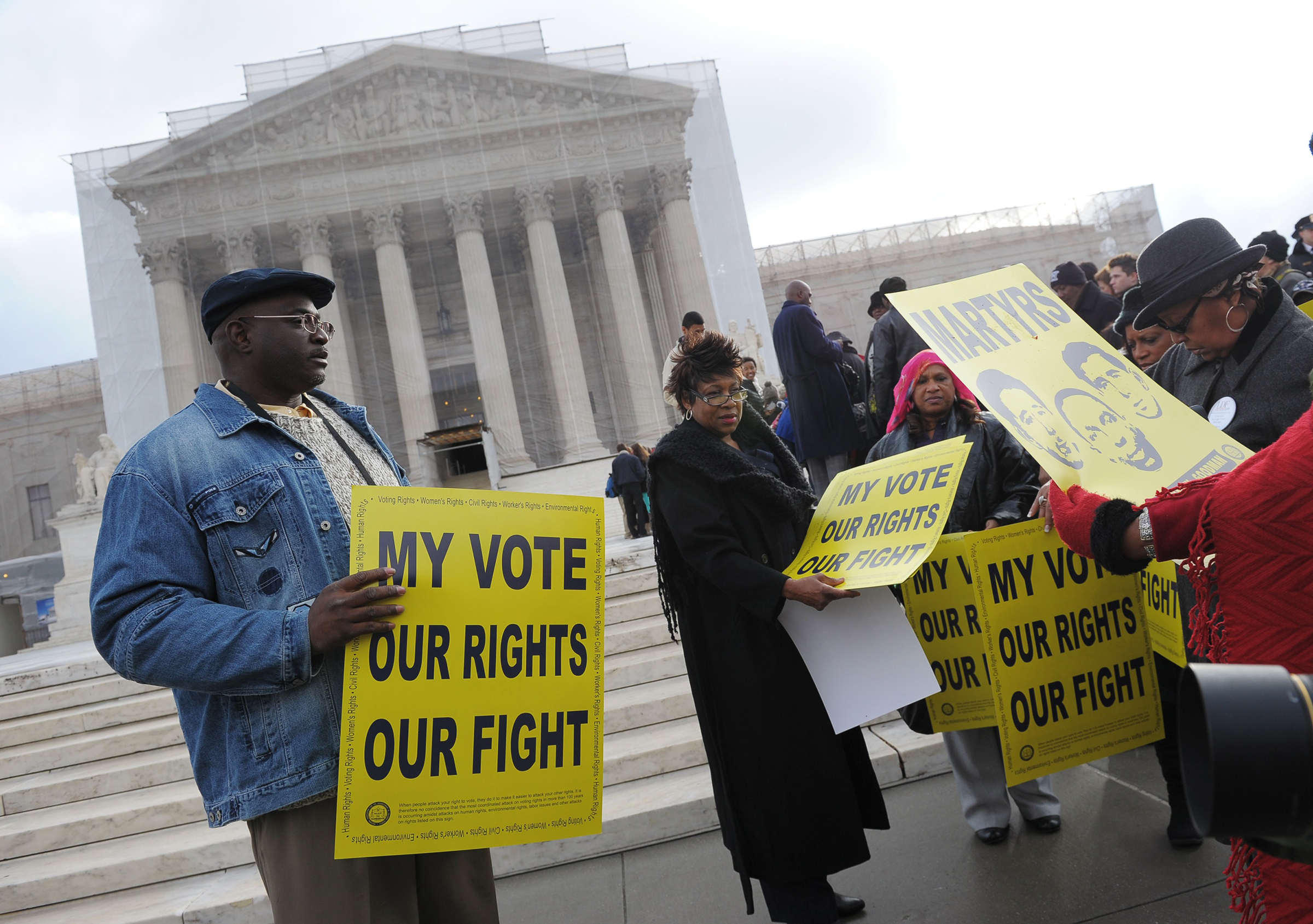 Activists distribute pro-voting rights placards outside the Supreme Court in Washington, D.C., on Feb. 27, 2013, as the Court prepares to hear Shelby County vs Holder. (Mandel Ngan—AFP/Getty Images)