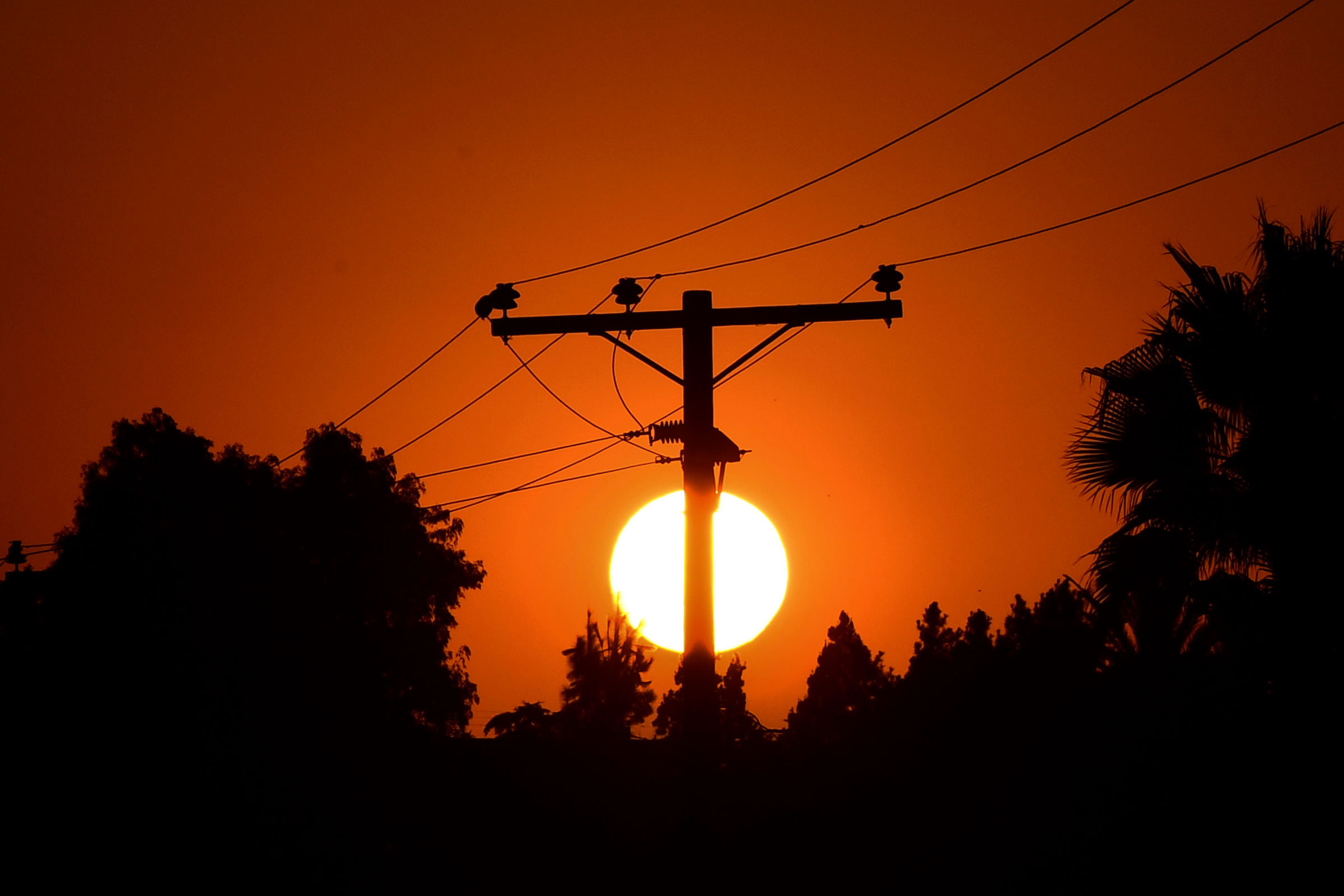 The sun sets behind power lines in Los Angeles, Calif. on Sept. 3, 2020. (Frederic J. Brown—AFP/Getty Images)