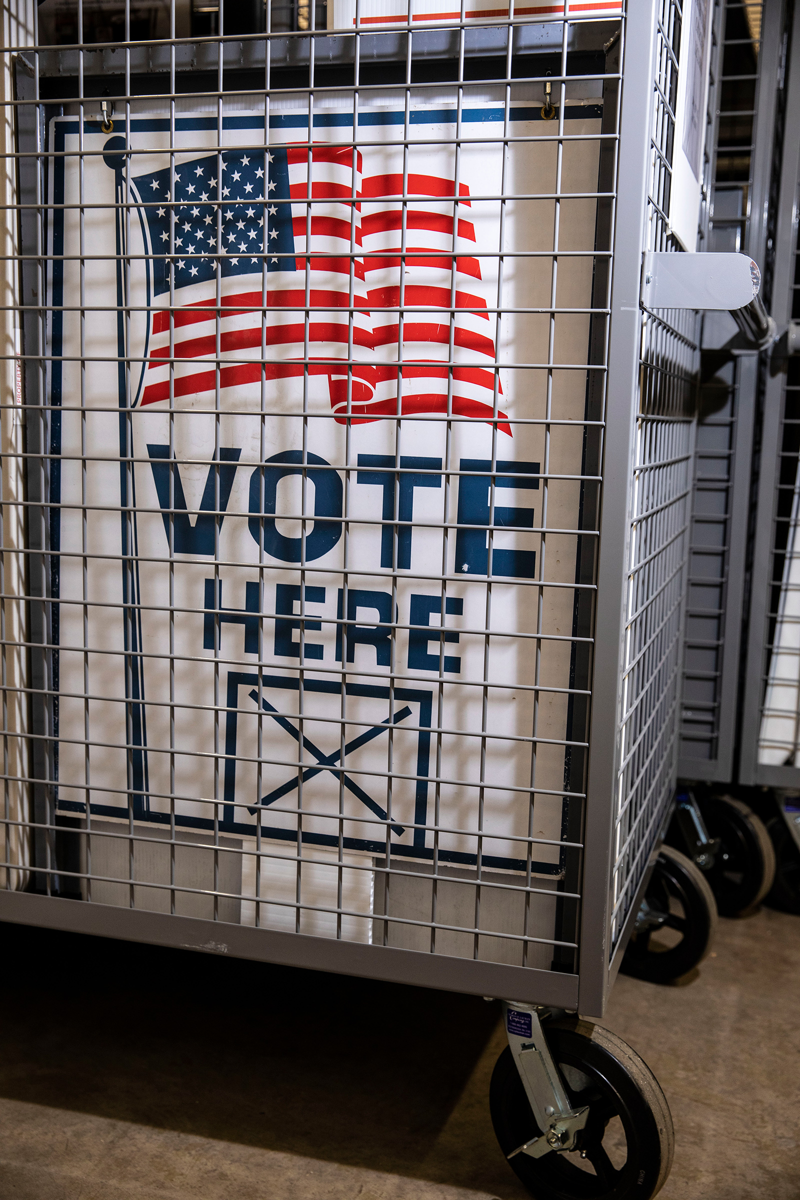 A locked cage at a secure county supervised storage facility on Sept. 8 in Davenport, IA, includes everything a precinct will need on election day, including a voting machine and signage thats all been prepped for delivery (David Guttenfelder for TIME)