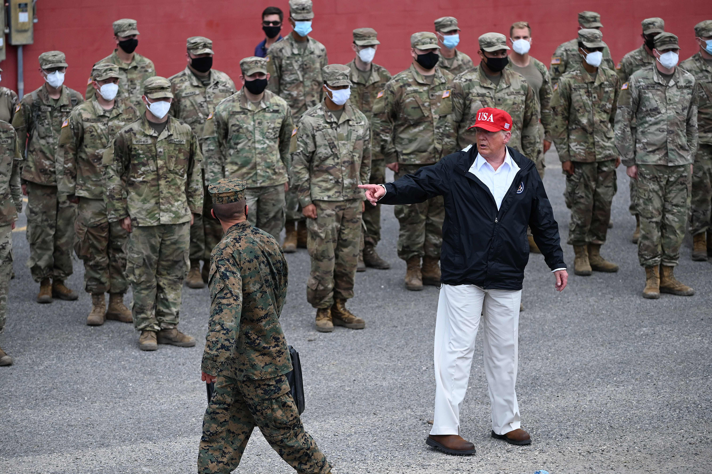 President Donald Trump poses with National Guard troops in Lake Charles, La., on Aug. 29, 2020. (Roberto Schmidt—AFP/Getty Images)