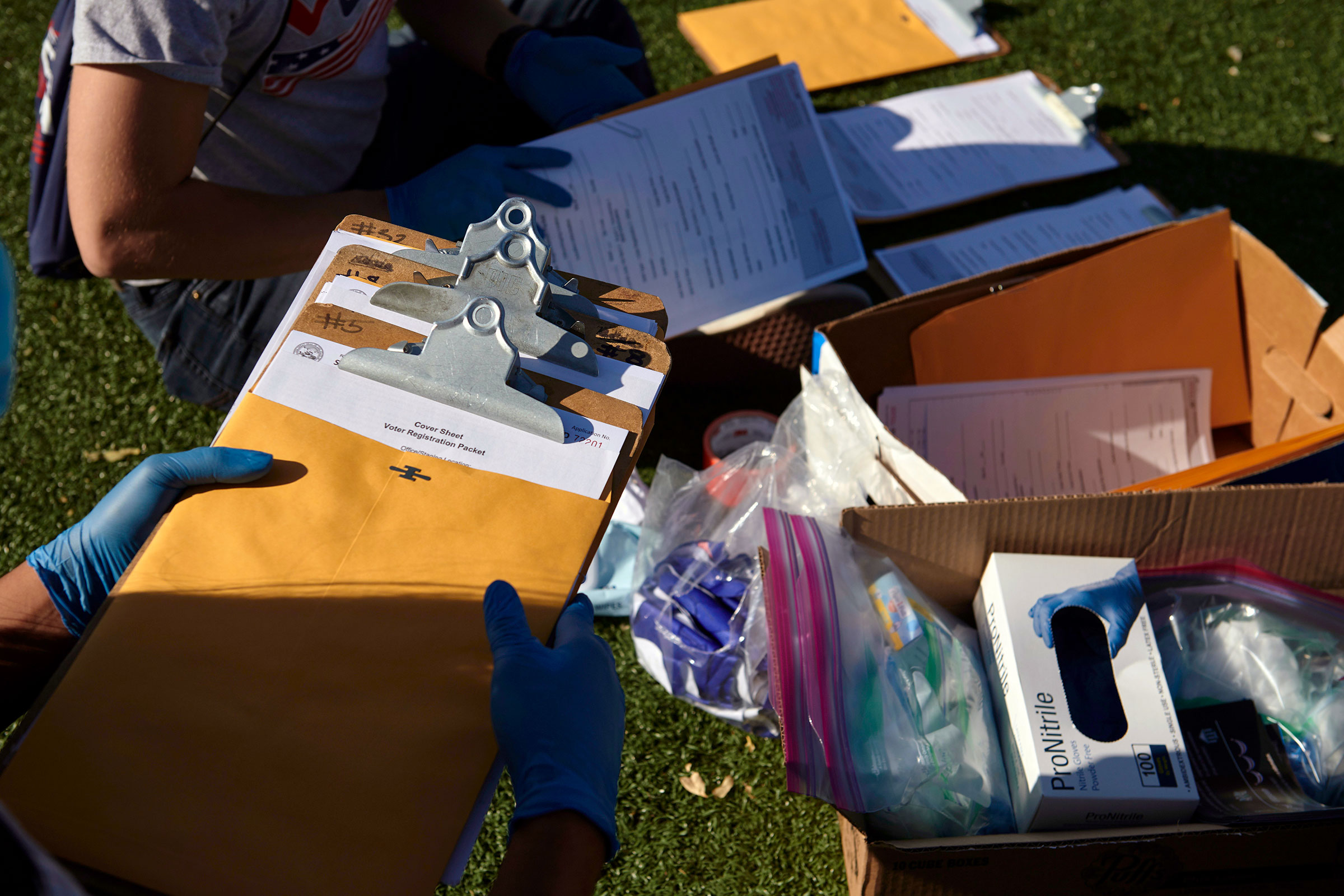 Mi Familia Vota workers organized their voter registration materials and personal protective equipment before canvassing in Las Vegas on Saturday, Sept. 12, 2020. (Bridget Bennett/The New York Times)