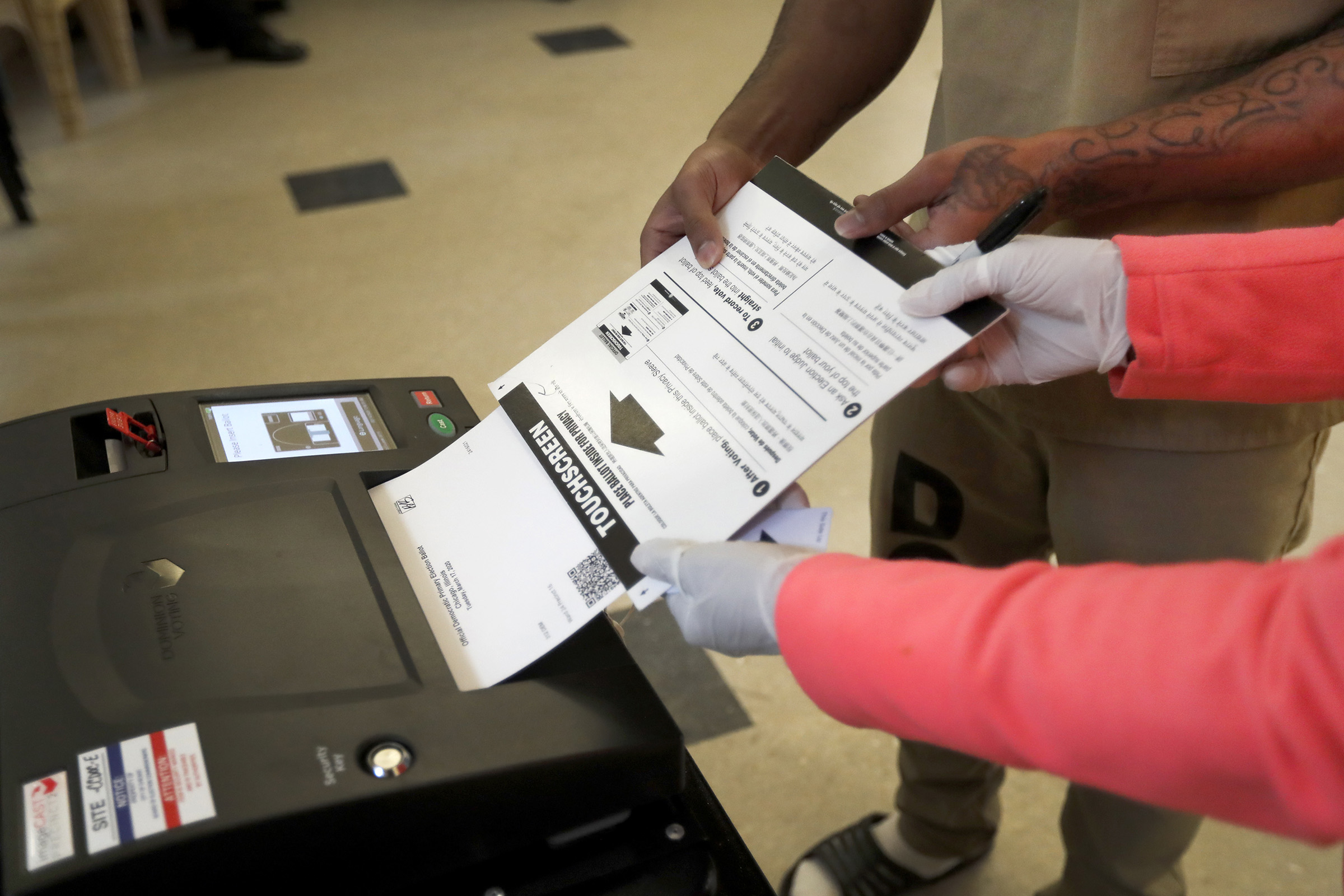 A Cook County jail inmate casts his ballot as he participates in early voting for the Illinois primary in Chicago on March 14, 2020. (Charles Rex Arbogast—AP)
