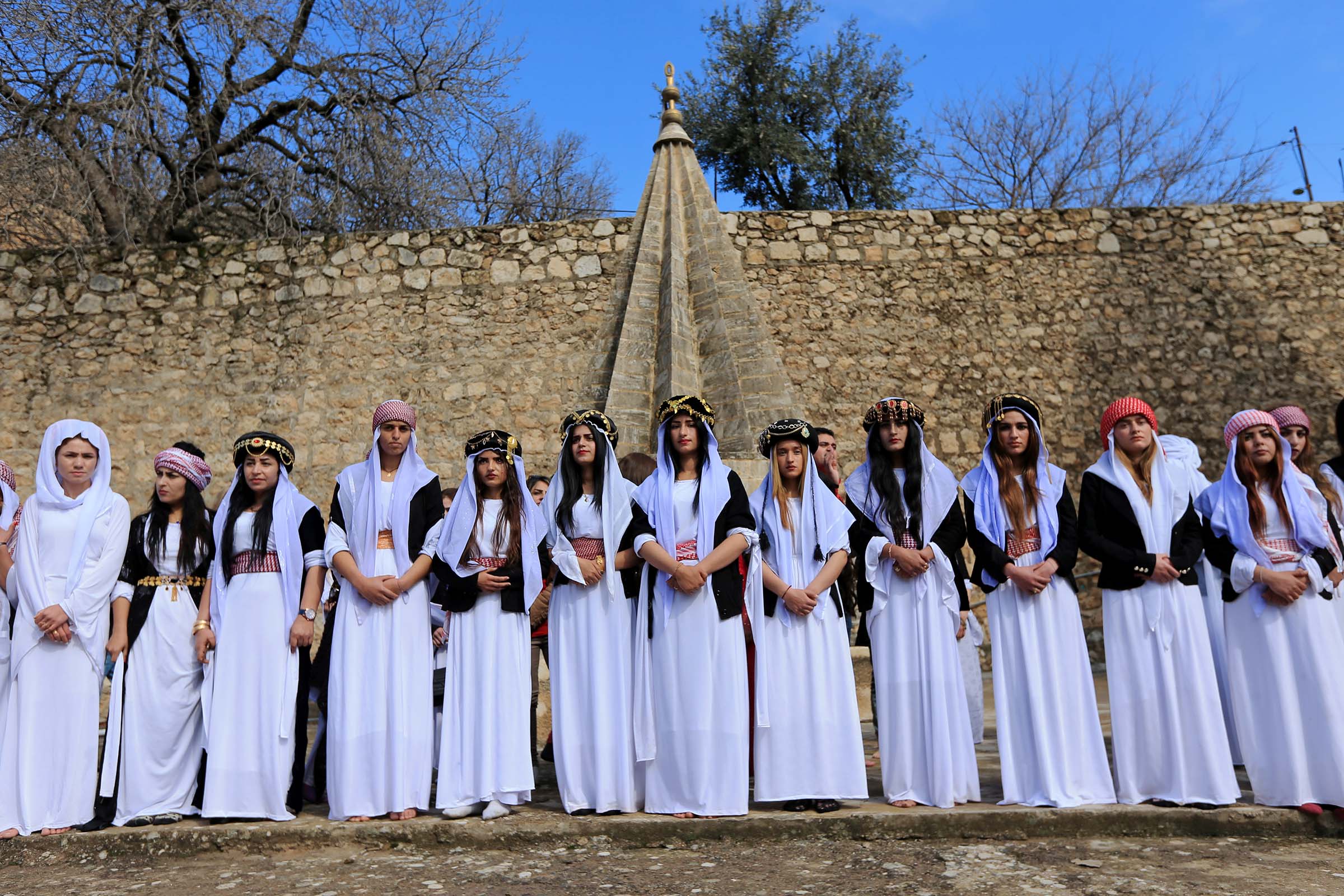 Yazidi women at a ceremony to commemorate the death of women killed by the Islamic State in Shikham, Iraq, on March 8, 2019. (Ari Jalal—Reuters)