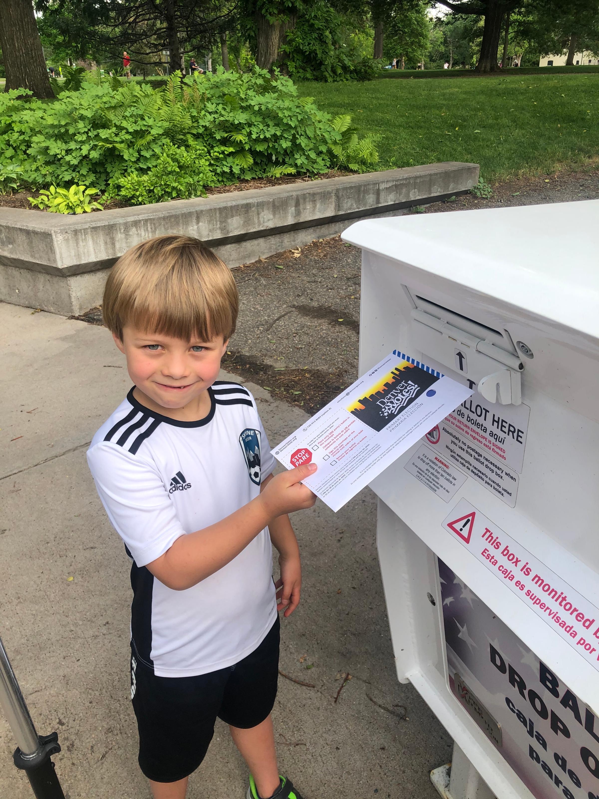 McReynolds' son Kenton, 7, helping her vote during Colorado's primary election this summer.