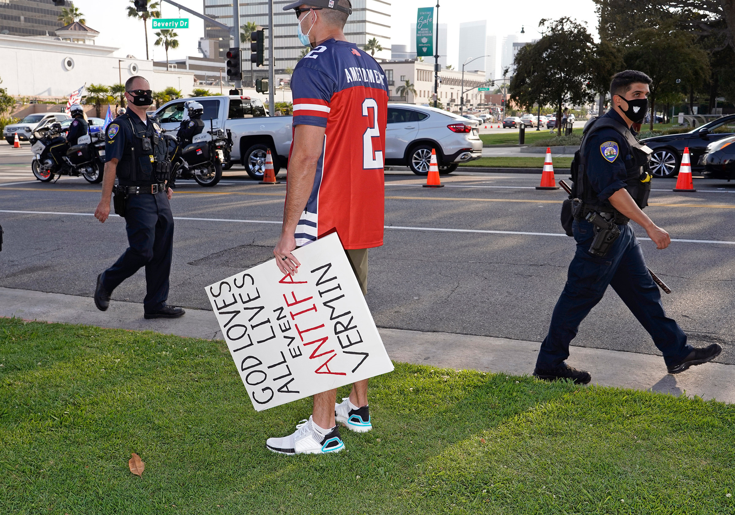 A man with an anti-antifa sign at a Trump rally in Beverly Hills, Calif., Oct. 10, 2020,