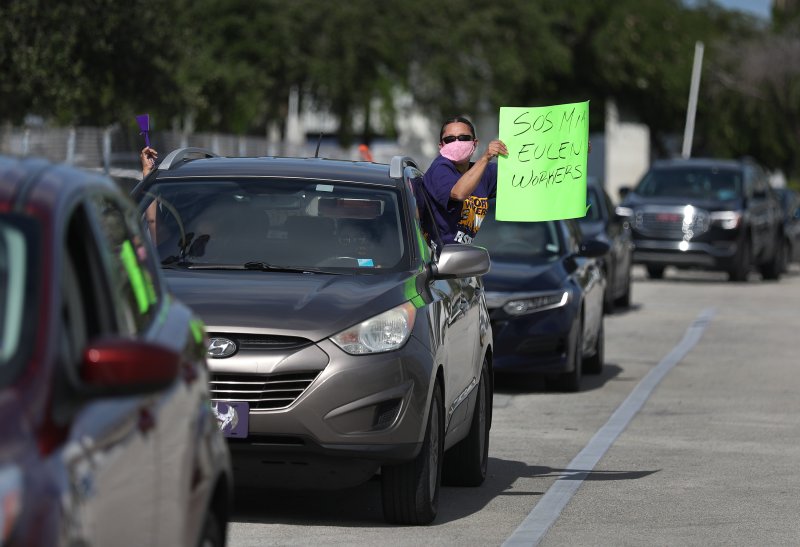 A protester at Miami International Airport on May 12, 2020, where workers were demonstrating against layoffs by the Eulen America aviation company.