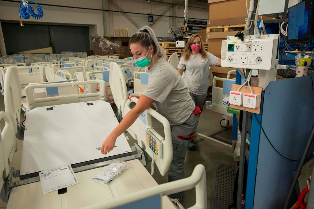Employees of Czech hospital beds maker Linet check beds to be used in the COVID-19 field hospital on Oct. 20, 2020 in the Linet factory in the village Zelevcice, 30 km south-east of Prague. (Michal Cizep/AFP—Getty Images)