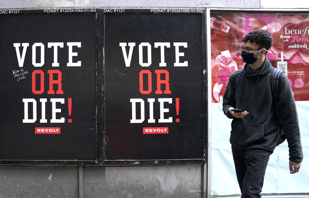 A man walks by a advertisement by REVOLT as they have relaunched Sean "Diddy" Combs' widely popular VOTE or DIE! initiative ahead of this year's general election on November 3, in the East Village in New York, New York, on October 20, 2020. (Timothy A. Clary — AFP/Getty Images)