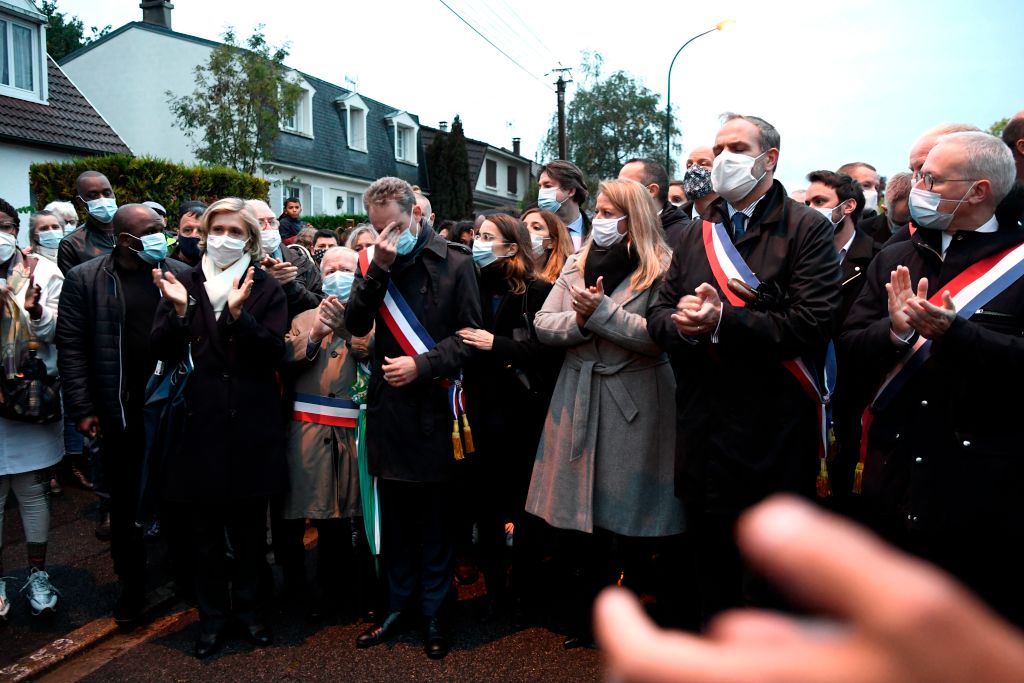 President of French Ile-de-France region Valerie Pecresse (1st L), mayor of Conflans Sainte-Honorine Laurent Brosse (C) and mayor of Eragny-sur-Oise Thibault Humbert (2nd R) attend the 'Marche Blanche' in Conflans-Sainte-Honorine, northwest of Paris, on October 20, 2020, in solidarity after a teacher was beheaded for showing pupils cartoons of the Prophet Mohammed (Bertrand Guay / AFP via Getty Images)