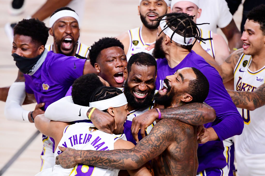LeBron James, #23 of the Los Angeles Lakers, celebrates with Quinn Cook, #28 of the Los Angeles Lakers, and teammates after winning the 2020 NBA Championship in Game Six of the 2020 NBA Finals at AdventHealth Arena at the ESPN Wide World Of Sports Complex on October 11, 2020 in Lake Buena Vista, Florida. (Photo by Douglas P. DeFelice/Getty Images)
