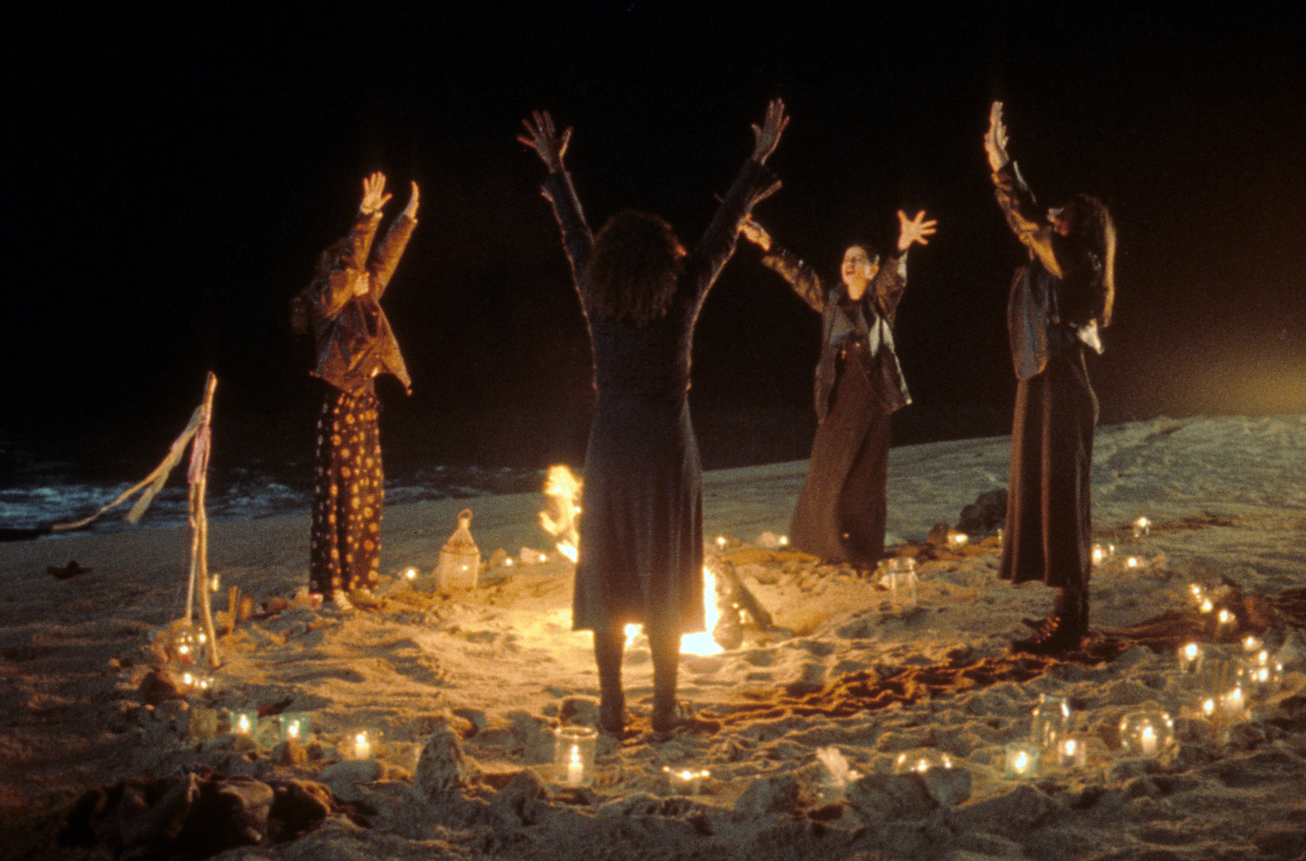 Robin Tunney, Fairuza Balk, Rachel True and Neve Campbell crowded around a fire, performing a ritual in a scene from the film 'The Craft', 1996. (Columbia Pictures/Getty Images)