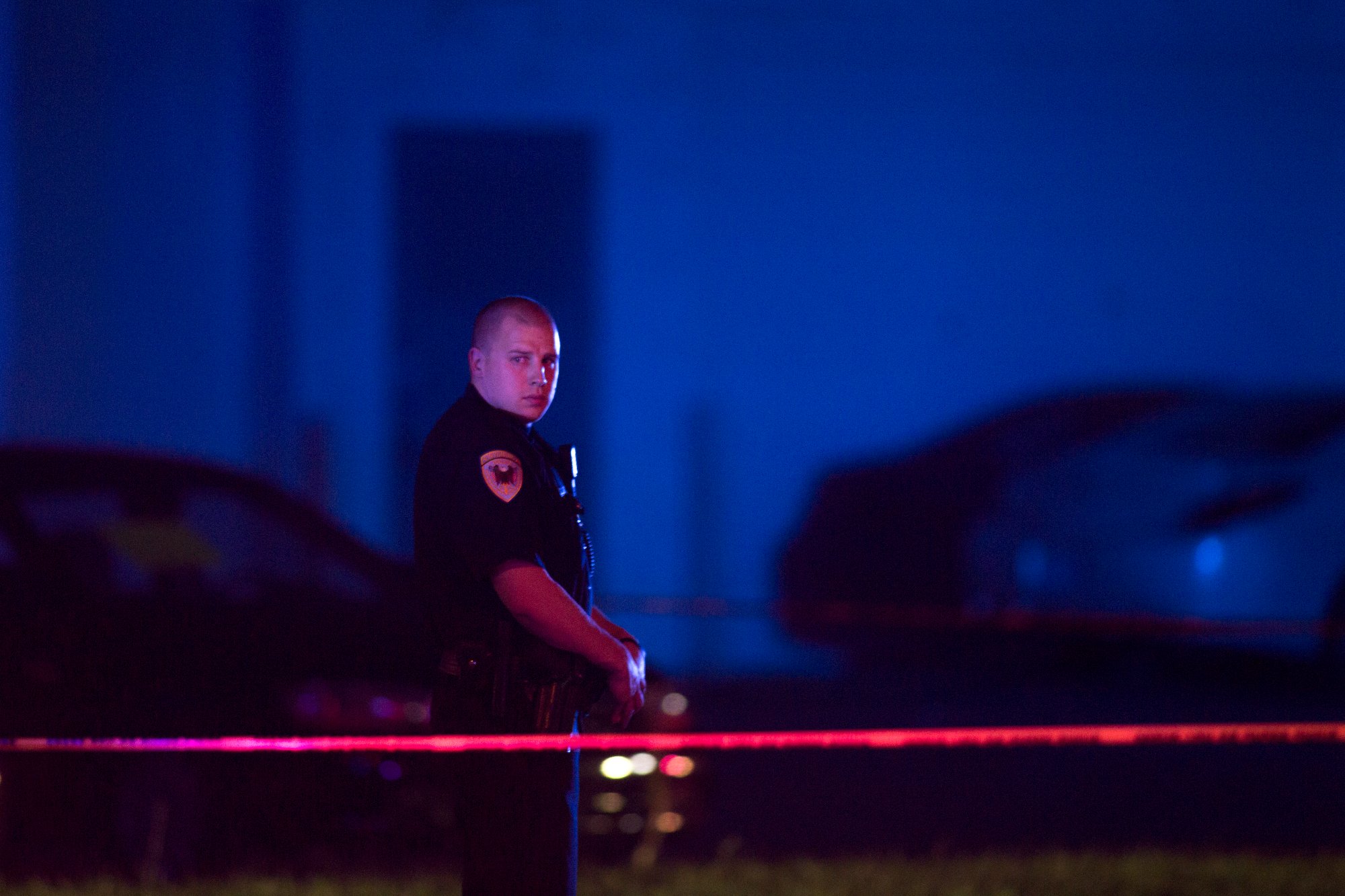 In this Sept. 7, 2016 photo, a police officer guards the scene after a police officer fatally shot a man who was suspected of stealing a semi-automatic pistol from a gun store in Wyoming, Mich., in the suburbs of Grand Rapids. Community leaders in Grand Rapids say the police can only do so much. They're looking for more proactive measures as opposed to reactive ones. (Tom Brenner—Grand Rapids Press/AP)