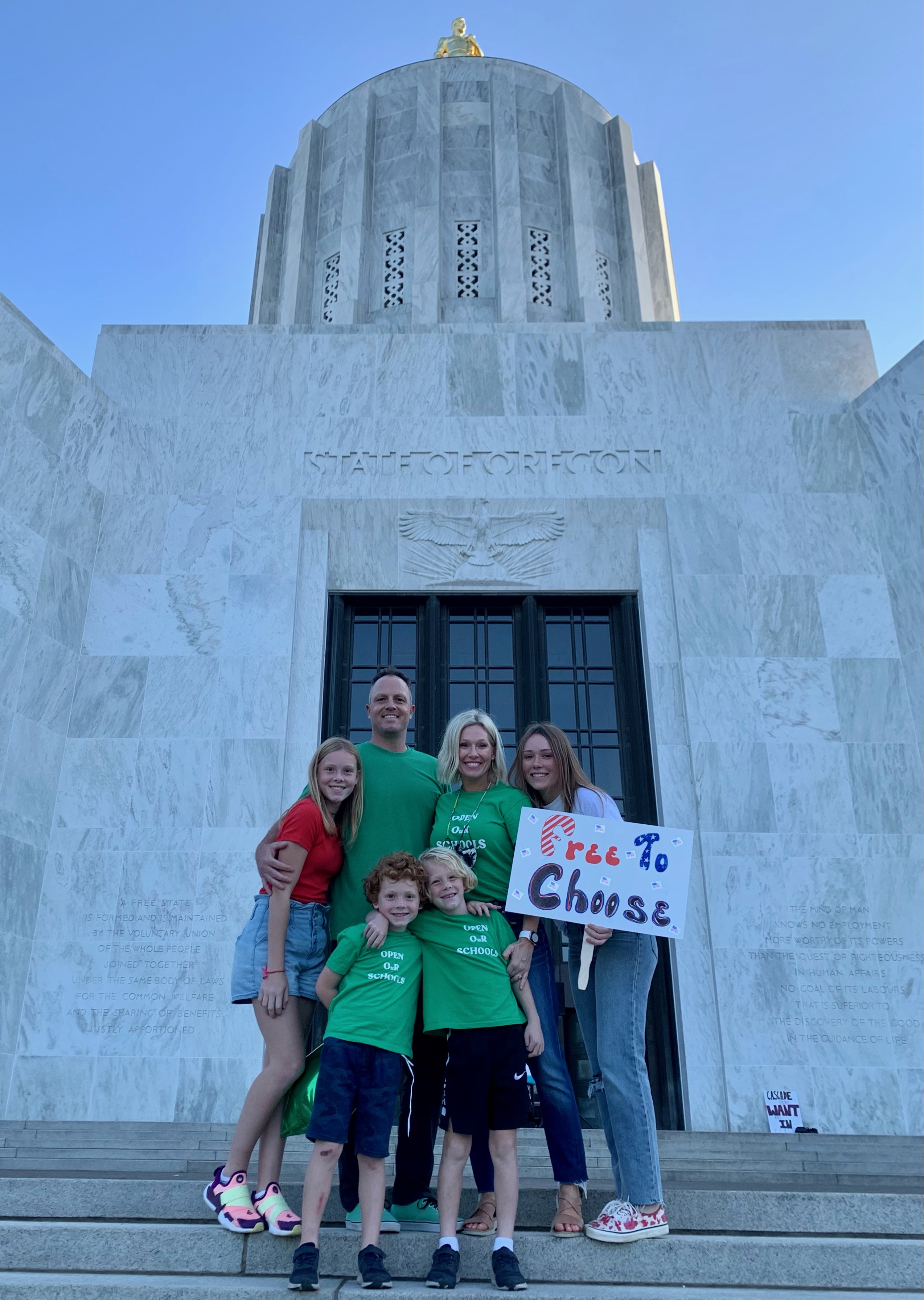 Shalyse Olson stands with her husband, Brian, and four children at the state capitol in Salem, Oregon during a rally.