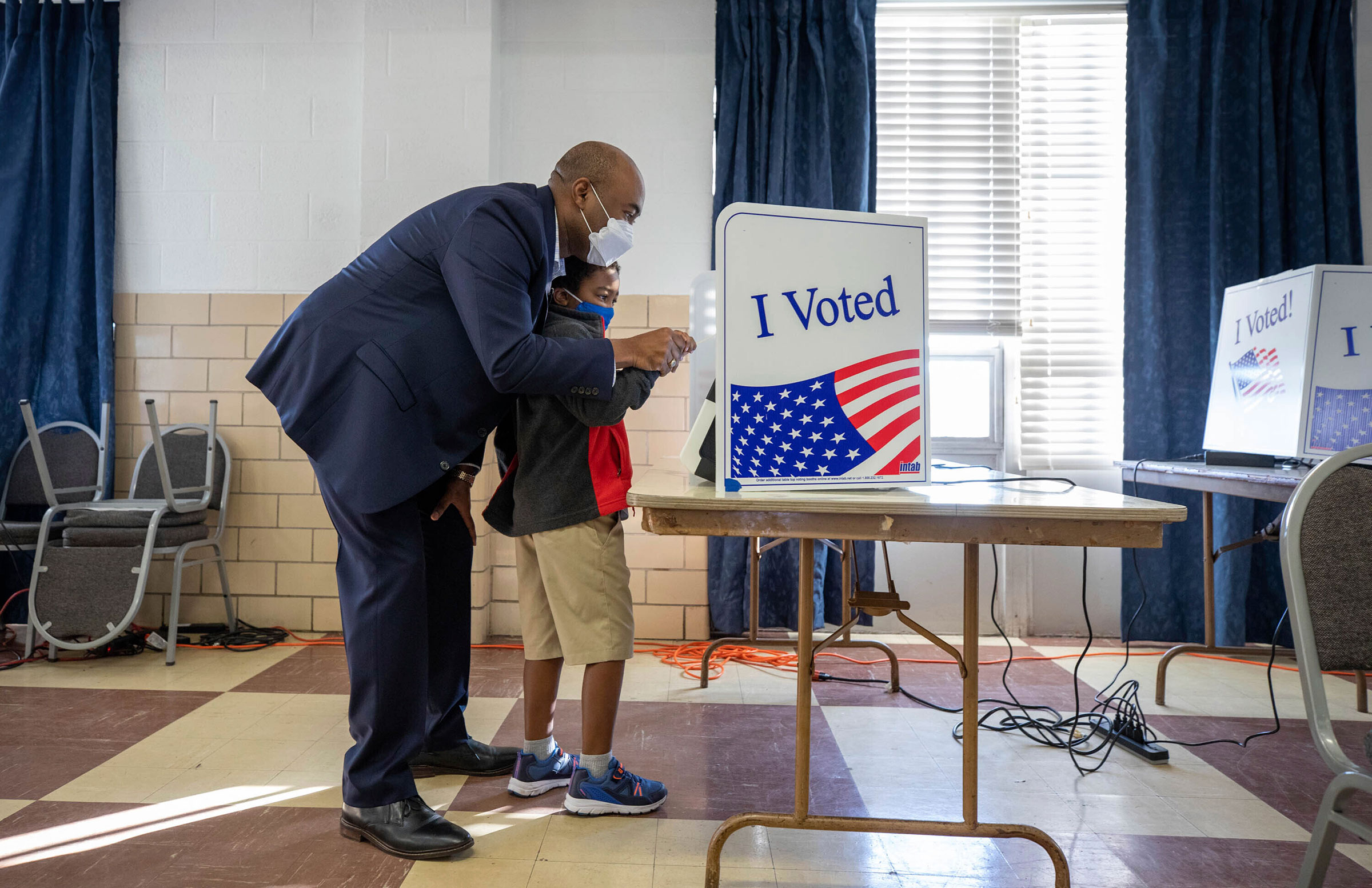 Senate candidate Jaime Harrison votes with his son, William, 6, at the Masonic Temple in Columbia, S.C. on Oct. 19, 2020.