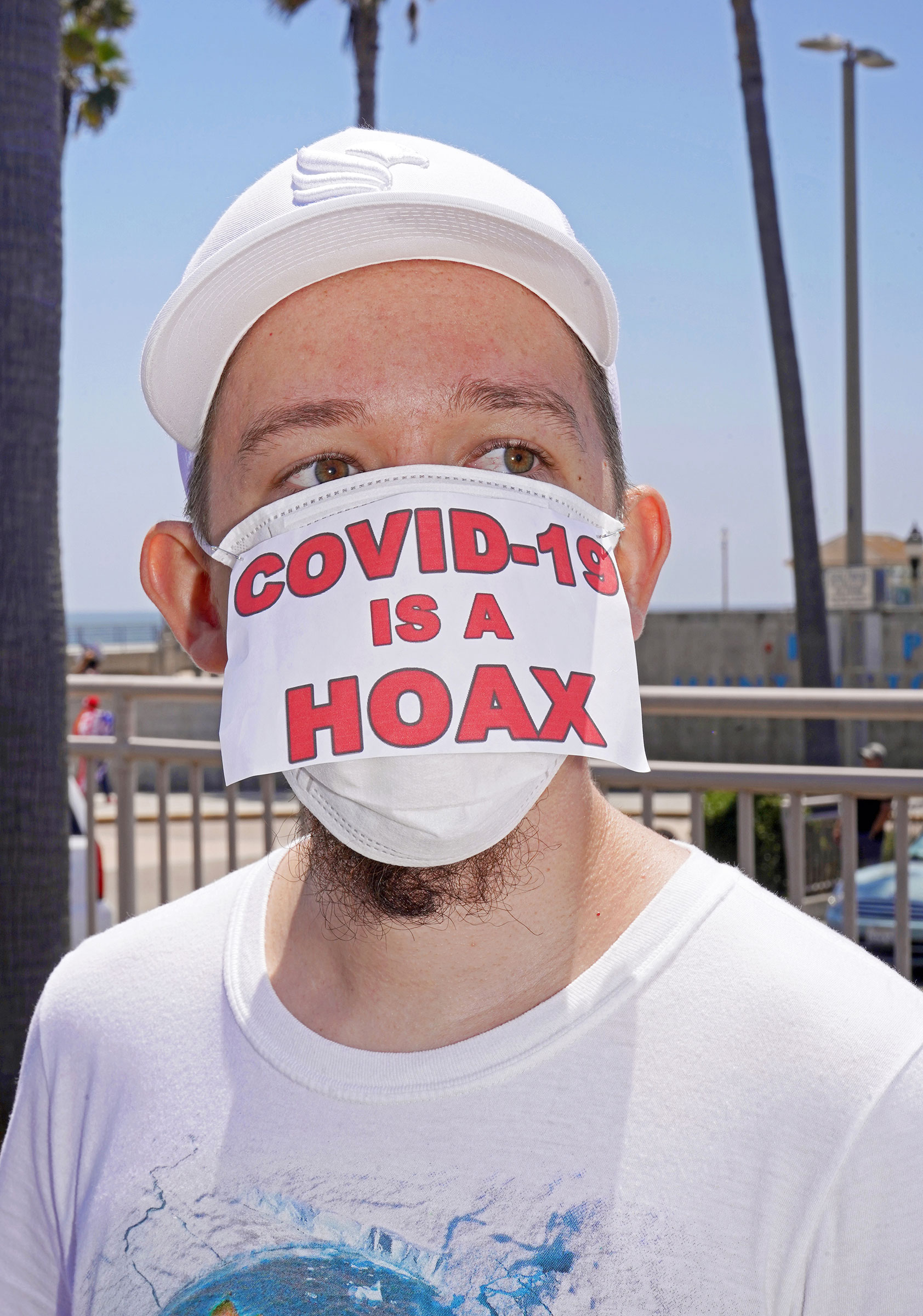 Conspiracy theories and misinformation on display at anti-lockdown rally in Huntington Beach, Calif., May 1, 2020. (Jamie Lee Curtis Taete)