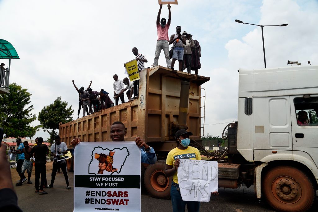 Protesters stand with banners on a truck forced to barricade the Lagos-Ibadan expressway during a demonstration to protest against police brutality and scrapping of Special Anti-Robbery Squad (SARS) in Lagos, on October 15, 2020. (Pius Utomi Ekpei—AFP via Getty Images)