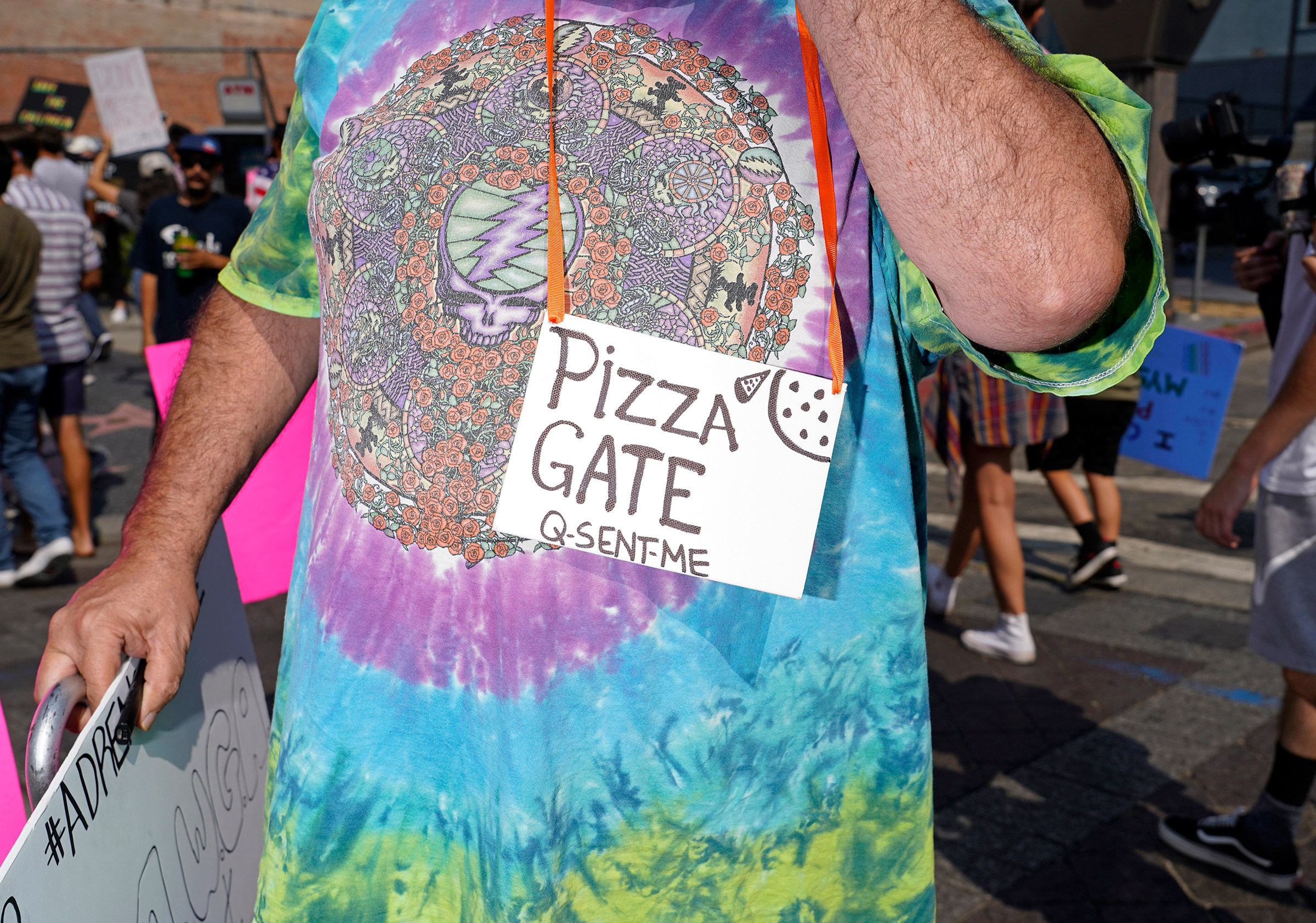 A protester with a Pizzagate and QAnon sign at a Save Our Children rally in Los Angeles, Aug. 22, 2020.