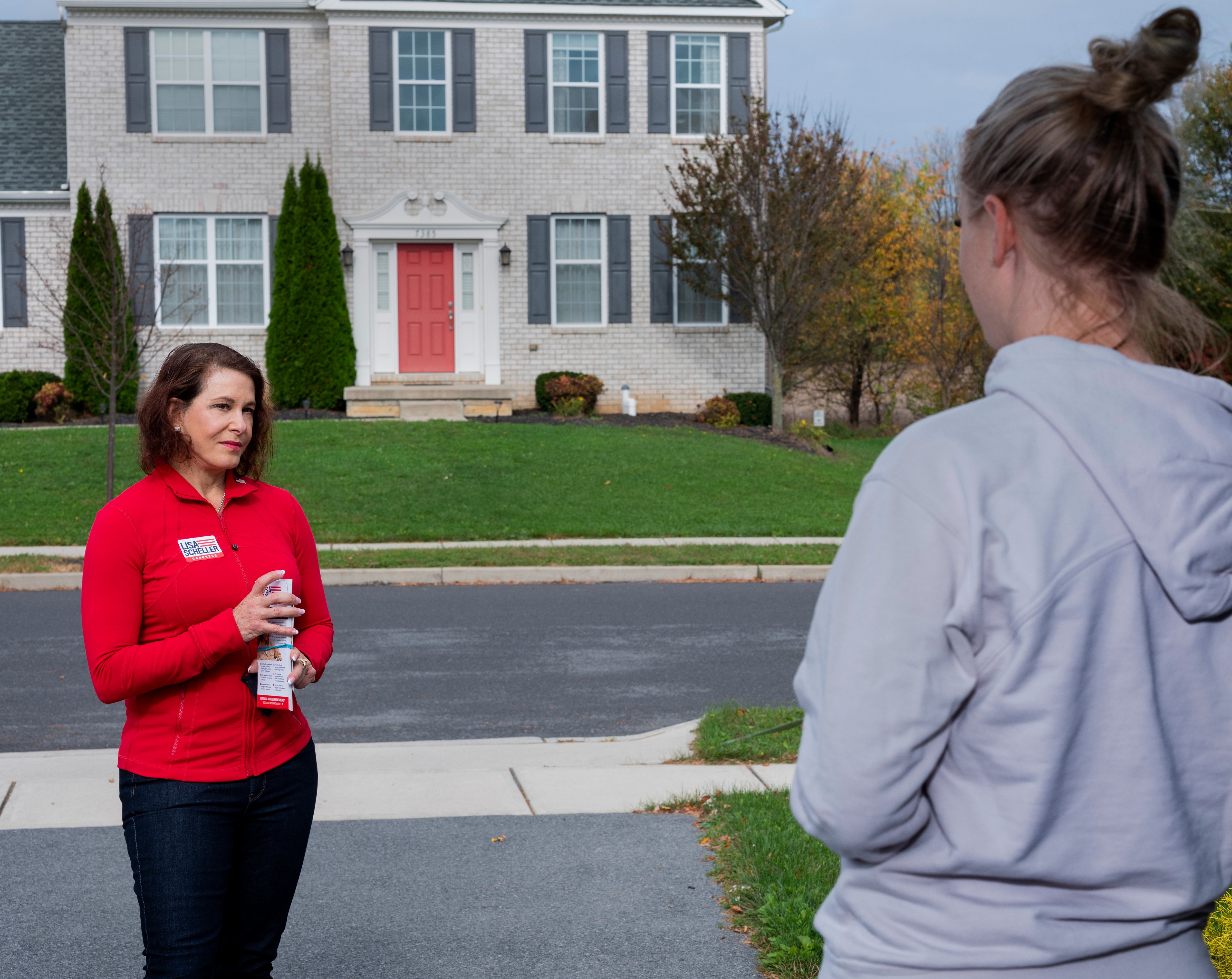 Republican nominee, Lisa Scheller, speaks with a resident while canvasing in Allentown, Pa., on Oct. 24, 2020. (Elizabeth Bick for TIME)