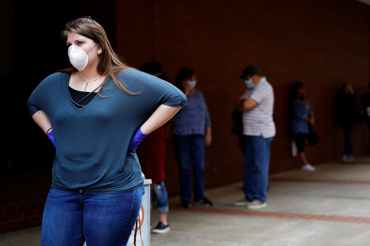 A woman who lost her job waits in line to file for unemployment following an outbreak of the coronavirus, at an Arkansas Workforce Center in Fort Smith, Ark., April 6, 2020. (Nick Oxford—REUTERS)