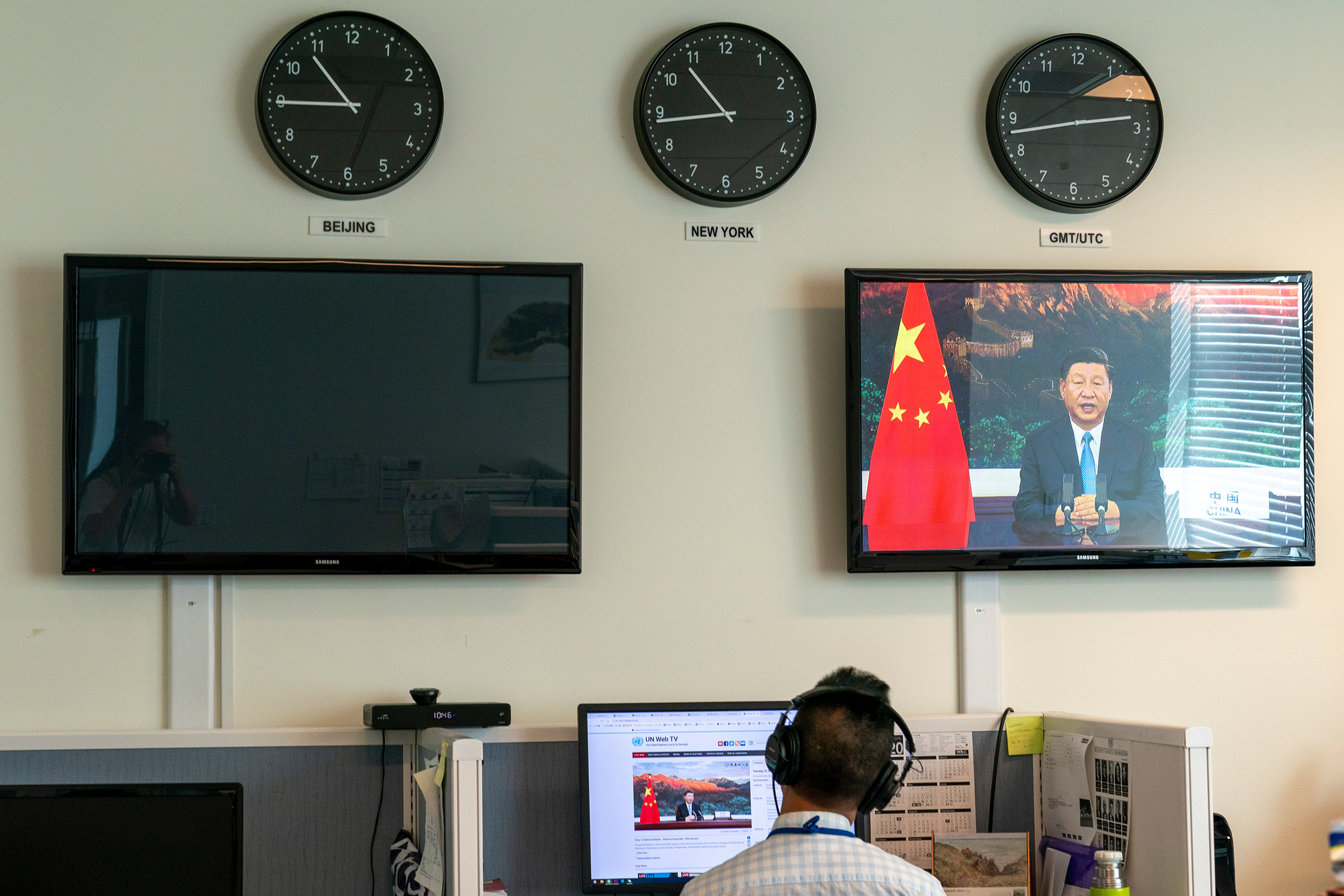 A Xinhua reporter watches as Xi remotely addresses the U.N. General Assembly on Sept. 22 (Mary Altaffer—AP)