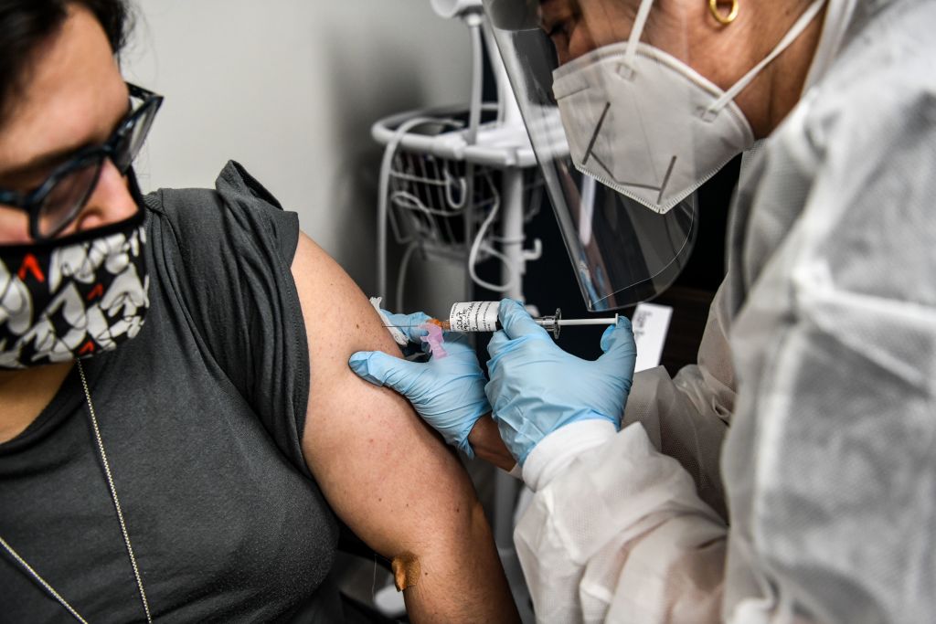 Heather Lieberman (L), 28, receives a COVID-19 vaccination from Yaquelin De La Cruz at the Research Centers of America in Hollywood, Florida, on August 13, 2020. (Chandan Khanna—AFP/Getty Images))