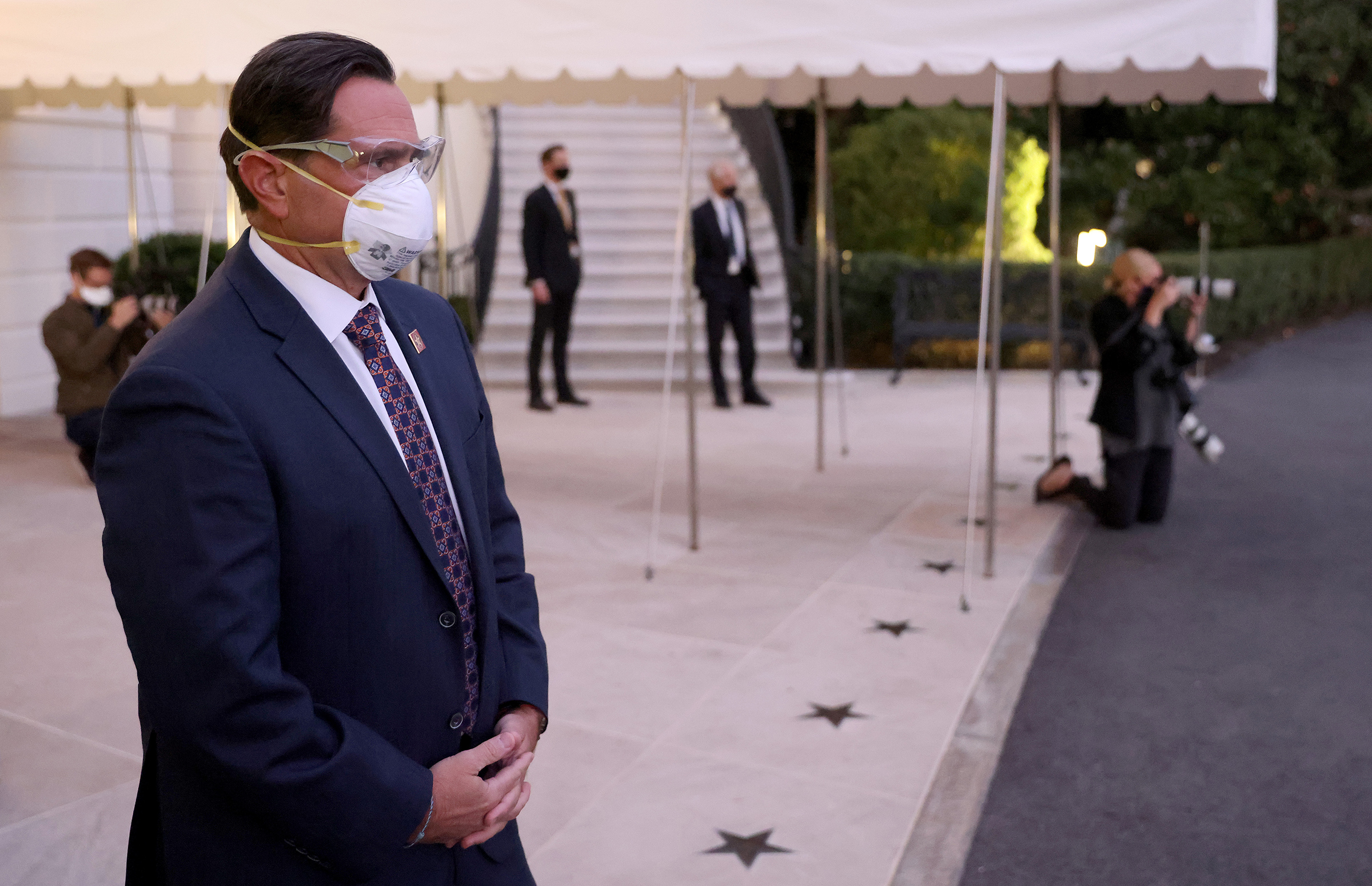 U.S. Service members wear masks and eye protection before President Trump's return to the White House from Walter Reed National Military Medical Center on Oct. 05