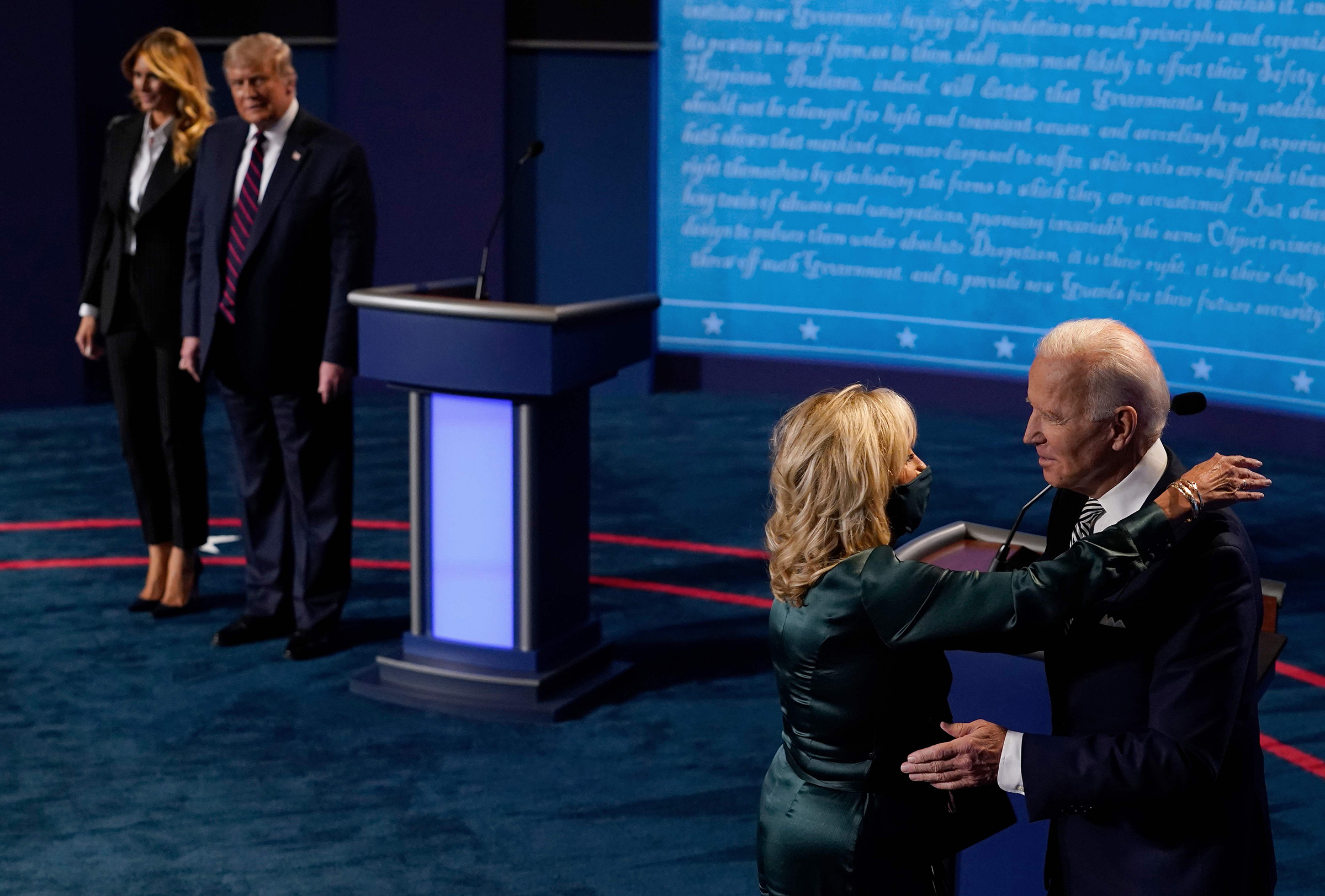 First Lady Melania Trump and President Donald Trump look on as Democratic presidential candidate and former Vice President Joe Biden hugs his wife, Jill Biden, after the first presidential debate in Cleveland on Sept. 29, 2020.