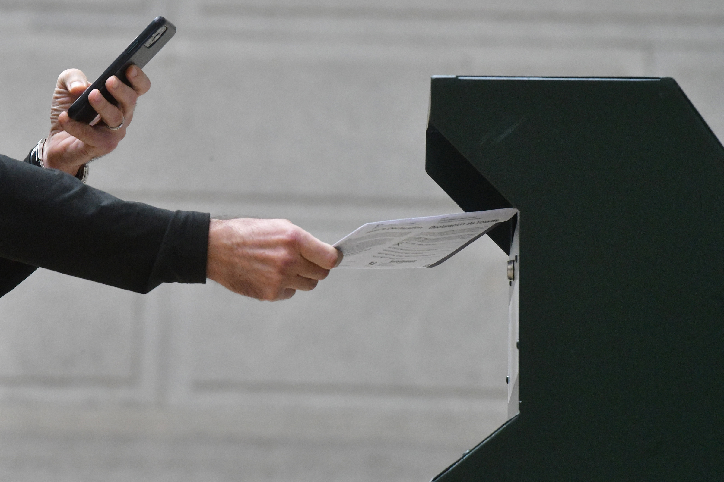 A man  photographs himself depositing his ballot in an official ballot drop box outside of Philadelphia City Hall on Oct. 27. Misinformation about voting has been spreading online (Mark Makela—Getty Images)