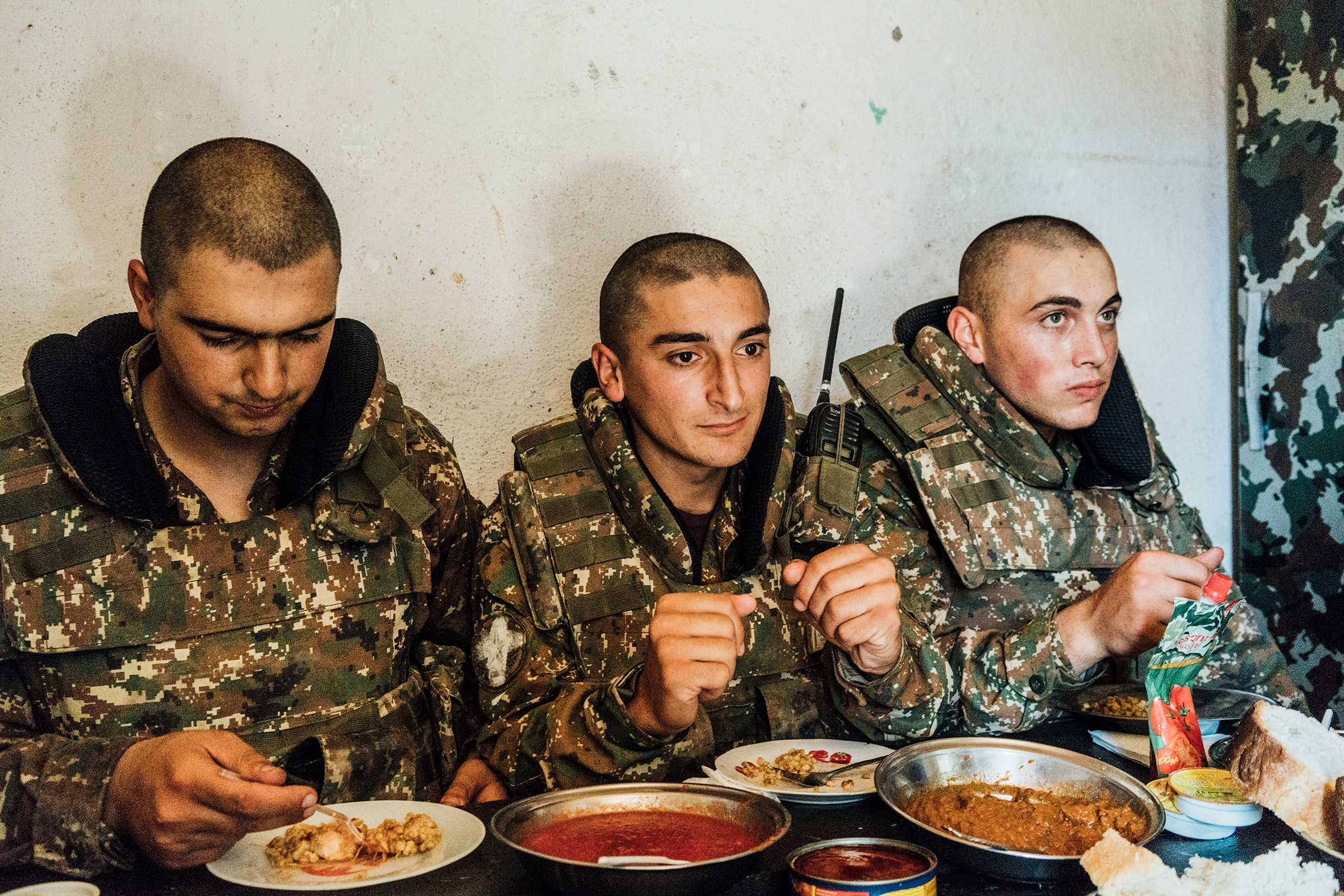 Armenian soldiers eat their rations inside a bunker on a frontline position near the town of Askeran.