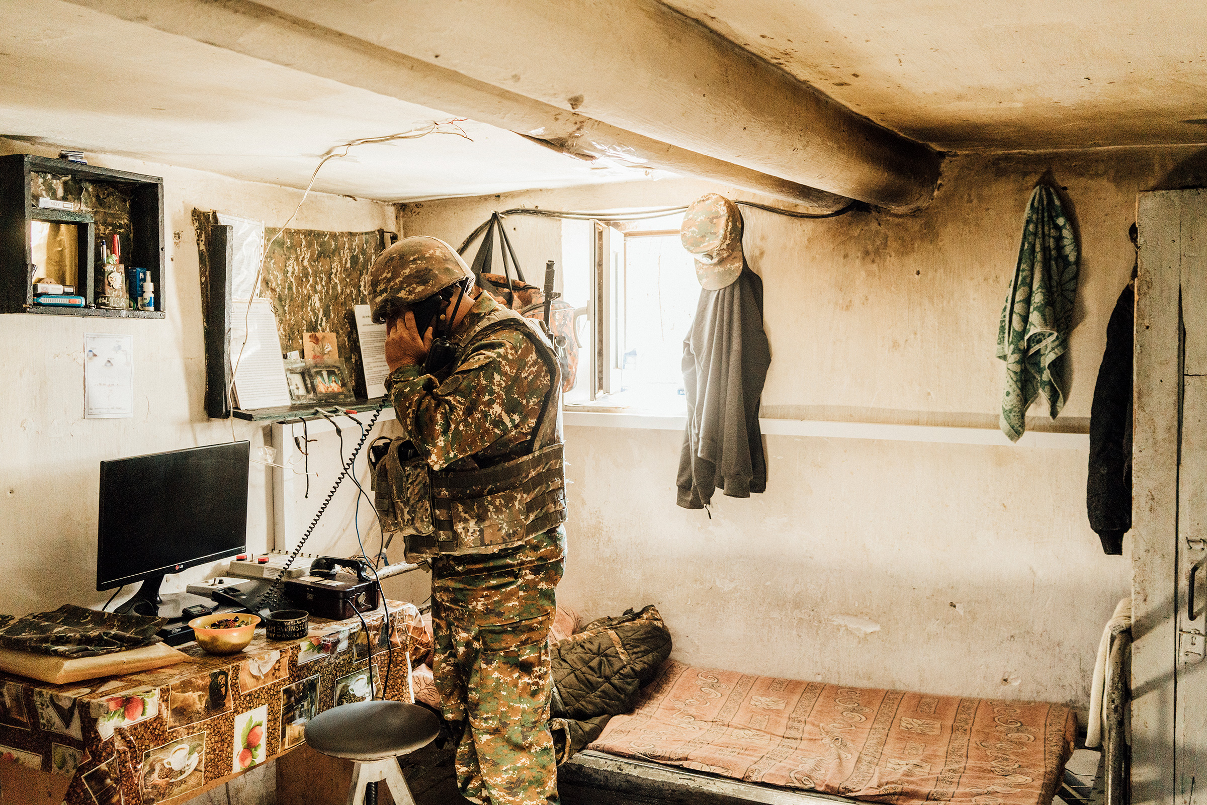 An Armenian soldier talks on a radio inside a bunker on a frontline position near Askeran. (Emanuele Satolli)