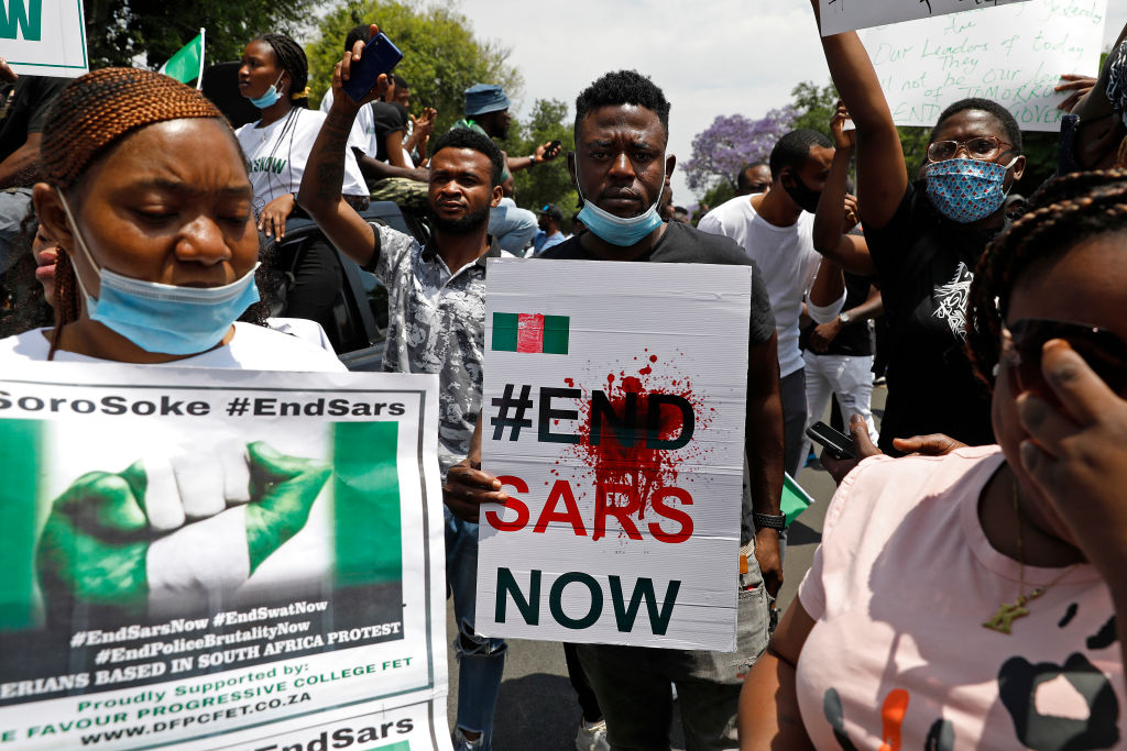 A Nigerian man based in South Africa holds a poster reading "#EndSARSNow" during a protest outside their embassy in Pretoria on Oct. 21, 2020 in solidarity with Nigerian youth. (Phill Magakoe—AFP/Getty Images)