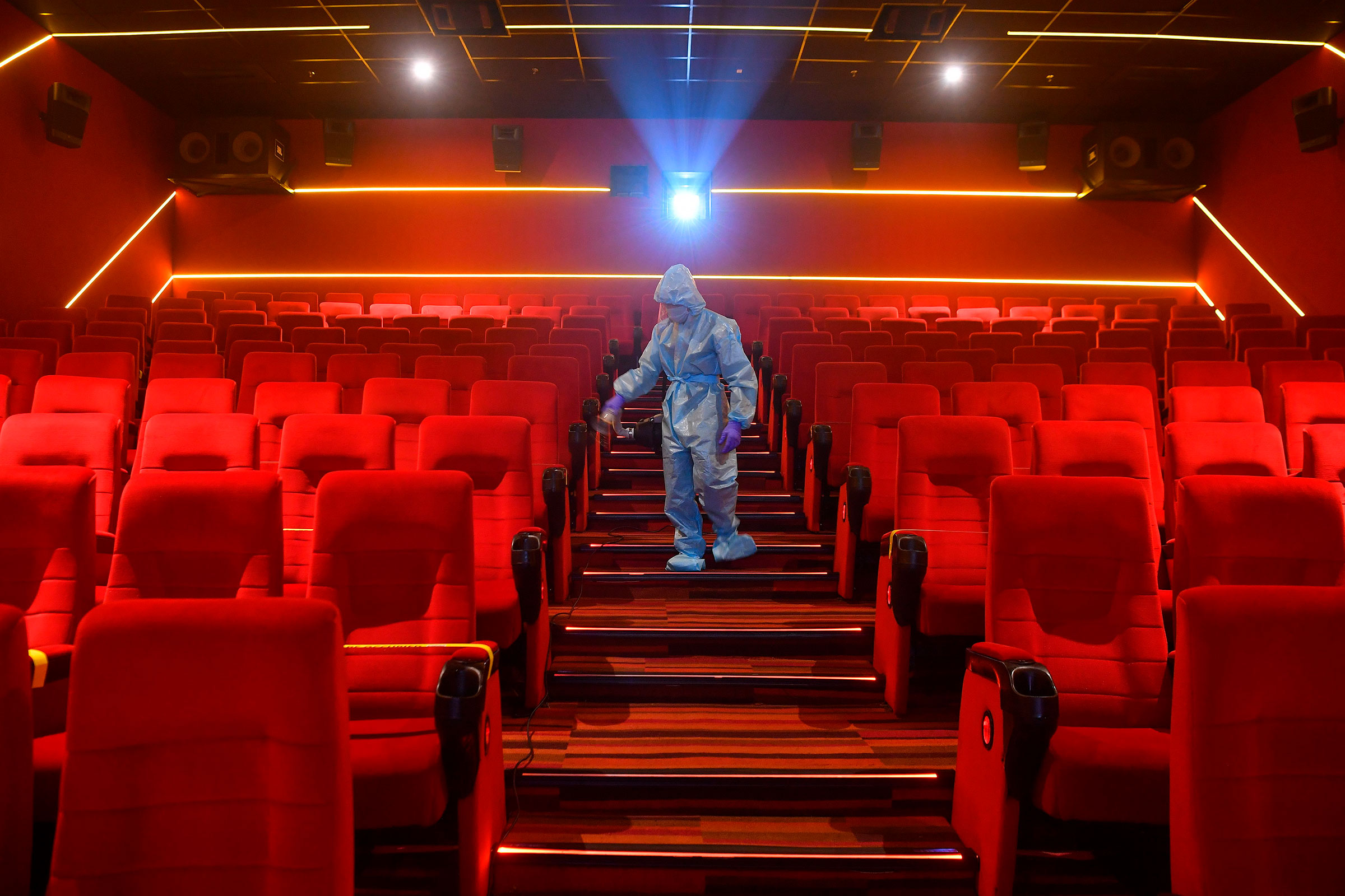 A worker sanitizes the inside of a movie theater ahead its reopening in Mumbai, October 13, 2020. (Indranil Mukherjee—AFP/Getty Images)