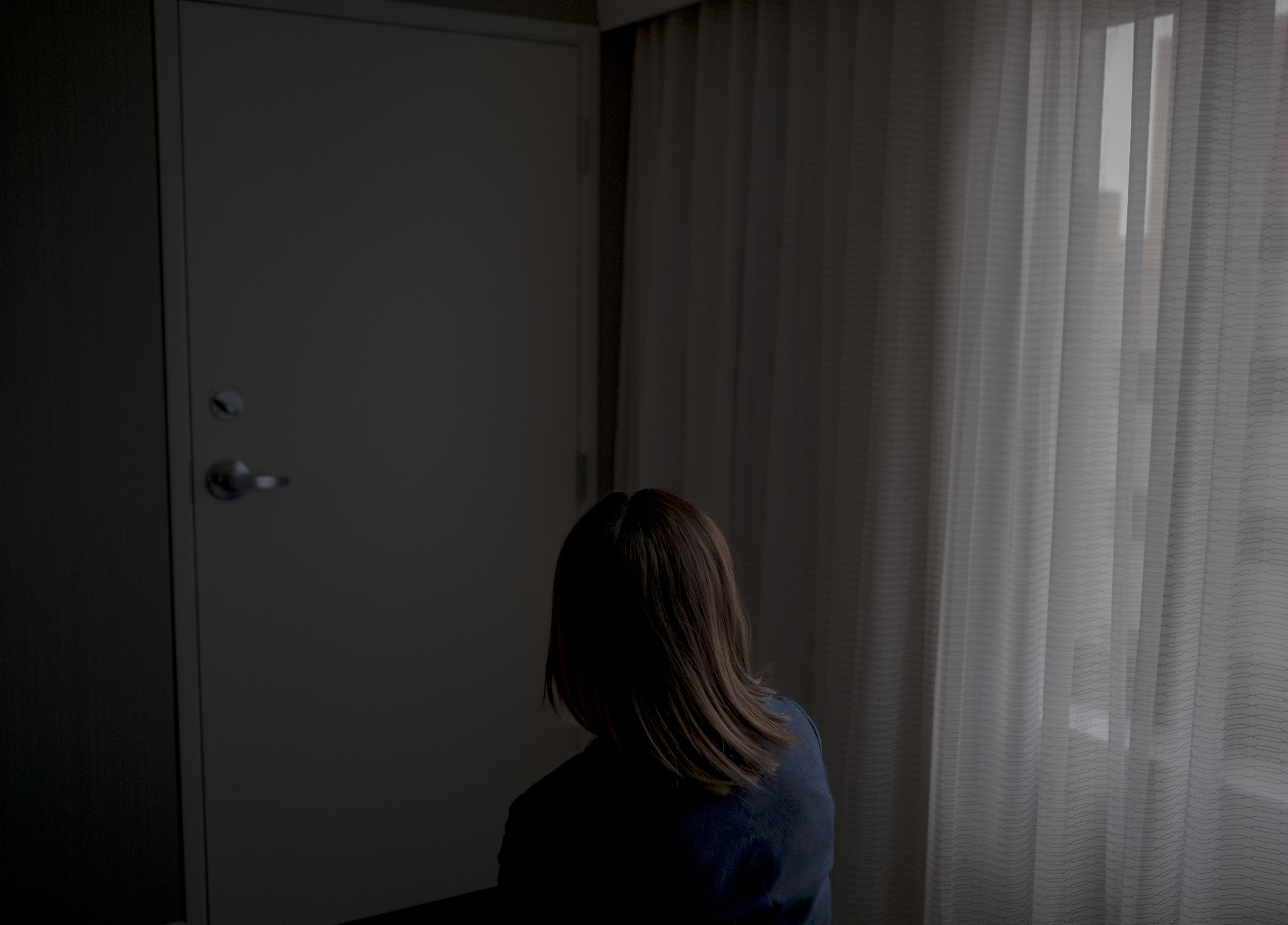 Emma, a human trafficking survivor from China, in a hotel room in Gaithersburg, MD on Feb. 25, 2020. (Gabriella Demczuk for TIME)