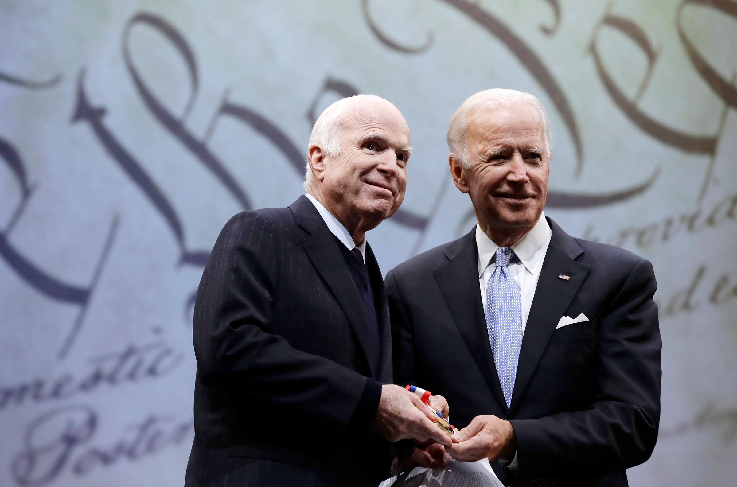 Sen. John McCain receives the Liberty Medal from former Vice President Joe Biden in Philadelphia, Oct. 16, 2017 (Matt Rourke—AP)