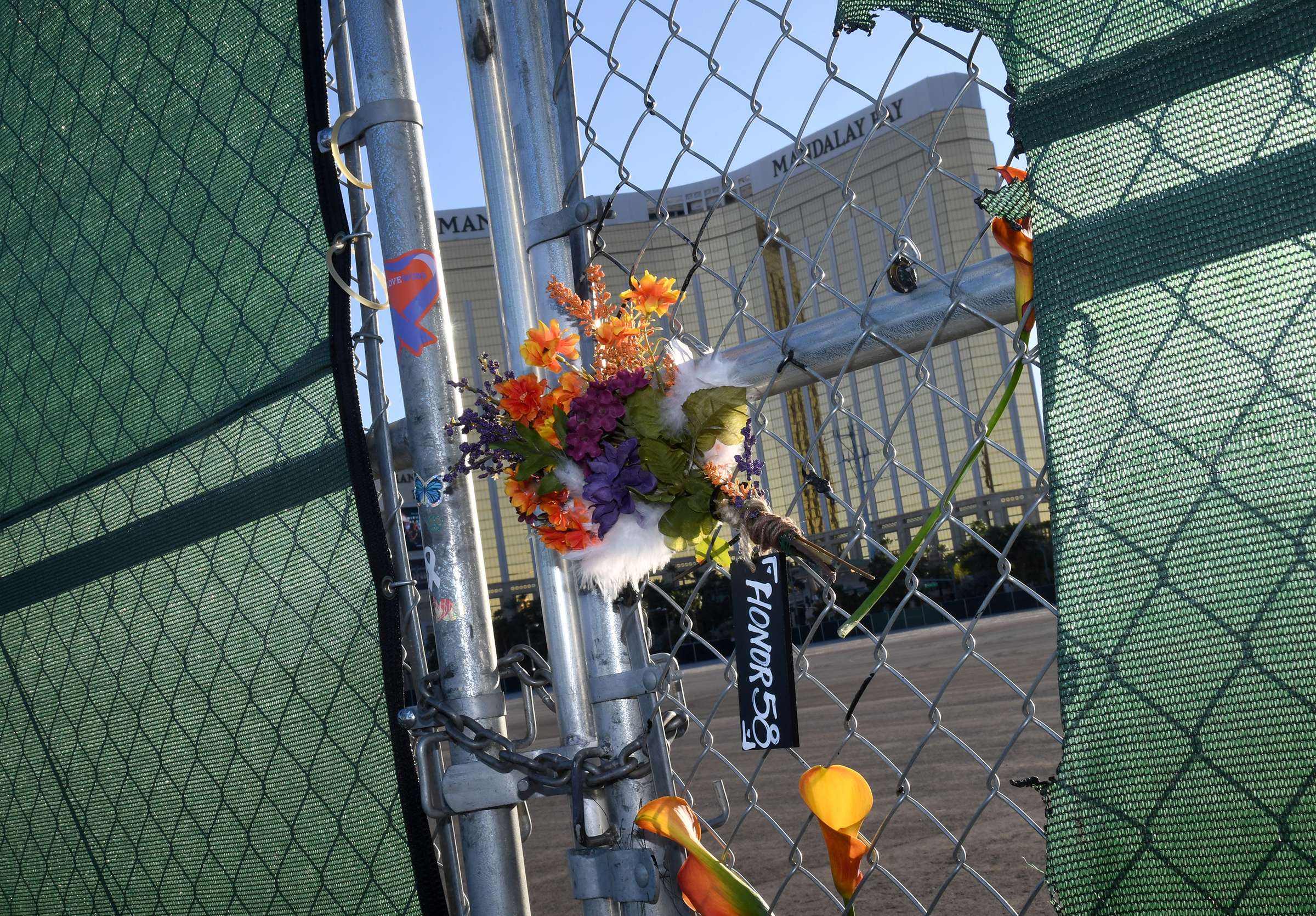 Flowers and a sign hang on a fence across from Mandalay Bay Resort and Casino as a tribute to those killed almost two years ago in a massacre at the site on Sept. 30, 2019 in Las Vegas