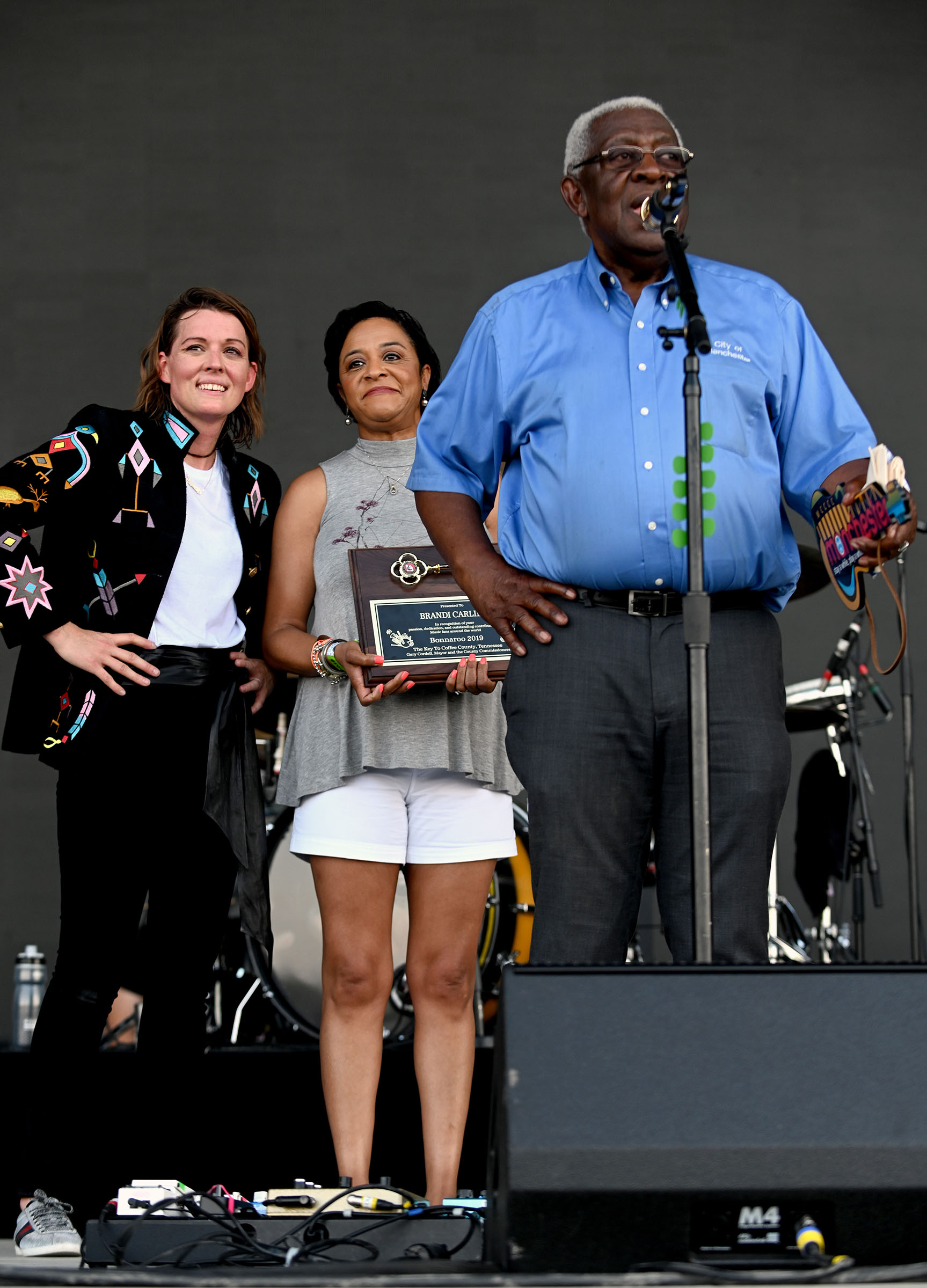 Manchester Mayor Lonnie Norman (far R) and Brandi Carlile (far L) onstage during the 2019 Bonnaroo Arts And Music Festival in Manchester, Tennessee on June 16, 2019. (FilmMagic for Bonnaroo Arts And Music Festival)