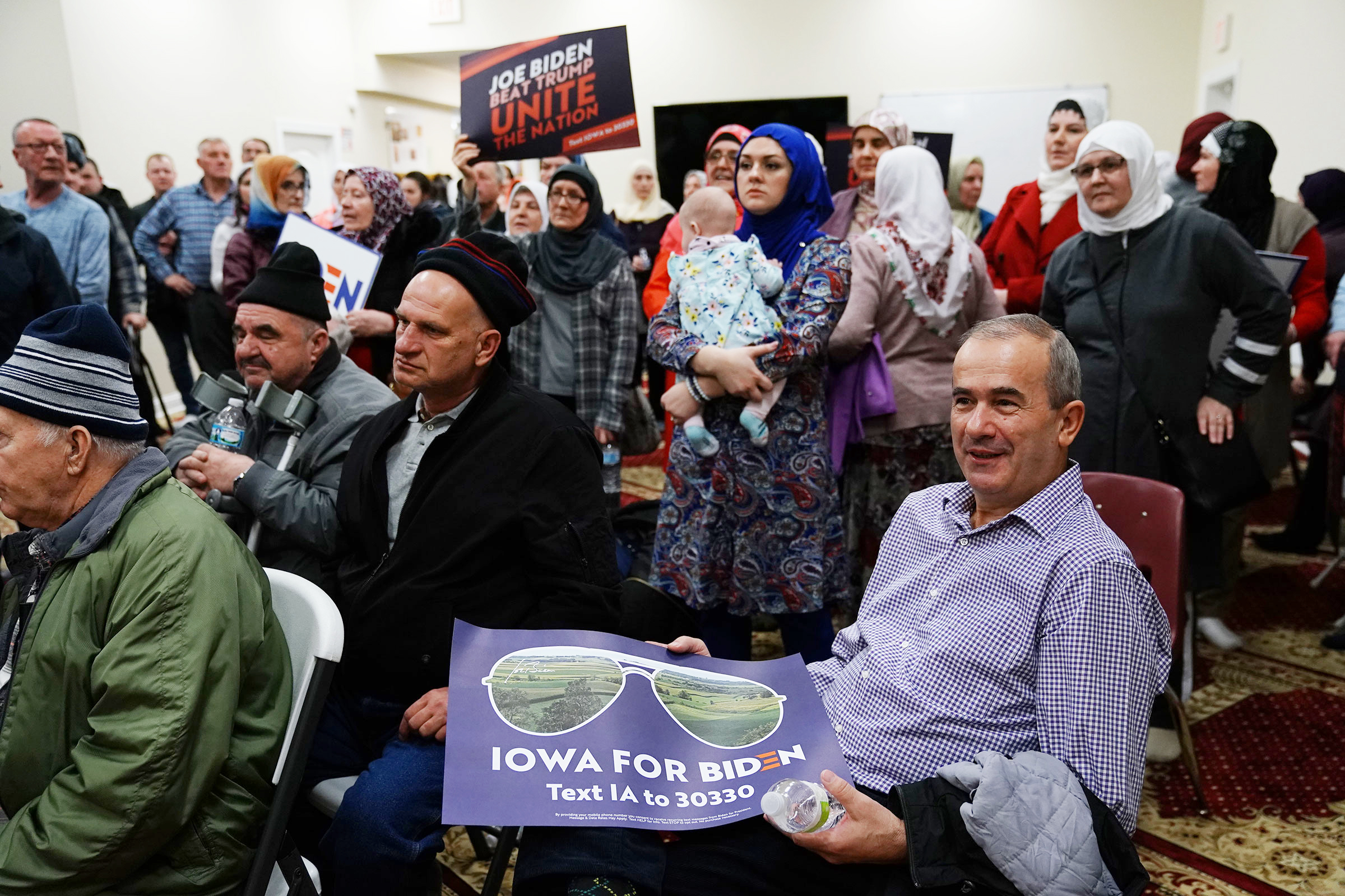 Participants hold campaign signs for Vice President Joe Biden during the first-in-the-nation Iowa caucus at the Islamic and Education Center Ezan mosque in Des Moines, Iowa on Feb. 3, 2020. (Elijah Nouvelage—Bloomberg/Getty Images)