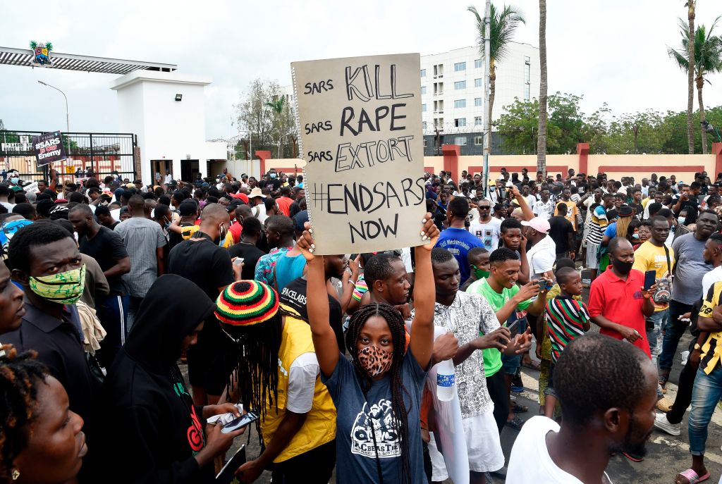 A girl carries a placard reading "Special Ant-Robbery Squad (SARS) Kill, SARS Rape, SARS Extort, End SARS Now" on the road to a government house in Ikeja, on Oct. 9, 2020. (Pius Utomi Ekpei—AFP/Getty Images)