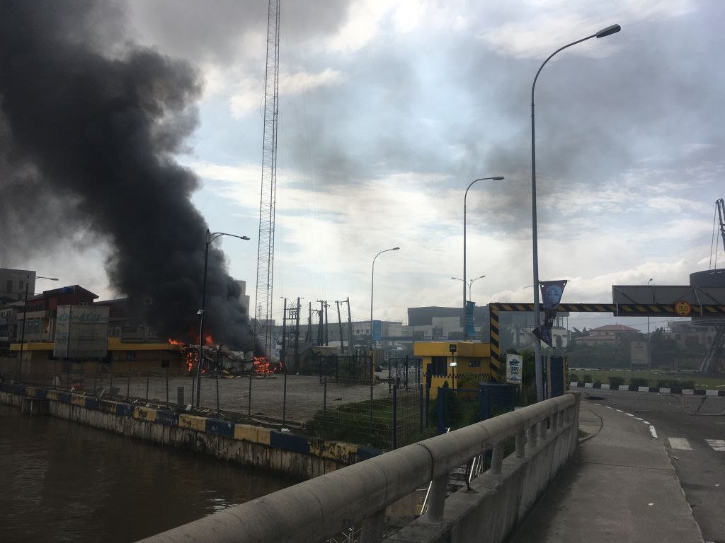A general view of a building on fire near the Lekki-Ikoyi Toll Gate in Lagos on Oct. 21, 2020, after a deadly shooting of peaceful protesters in Lagos that Amnesty International blamed on security forces. (Sophie Bouillon—AFP/Getty Images)