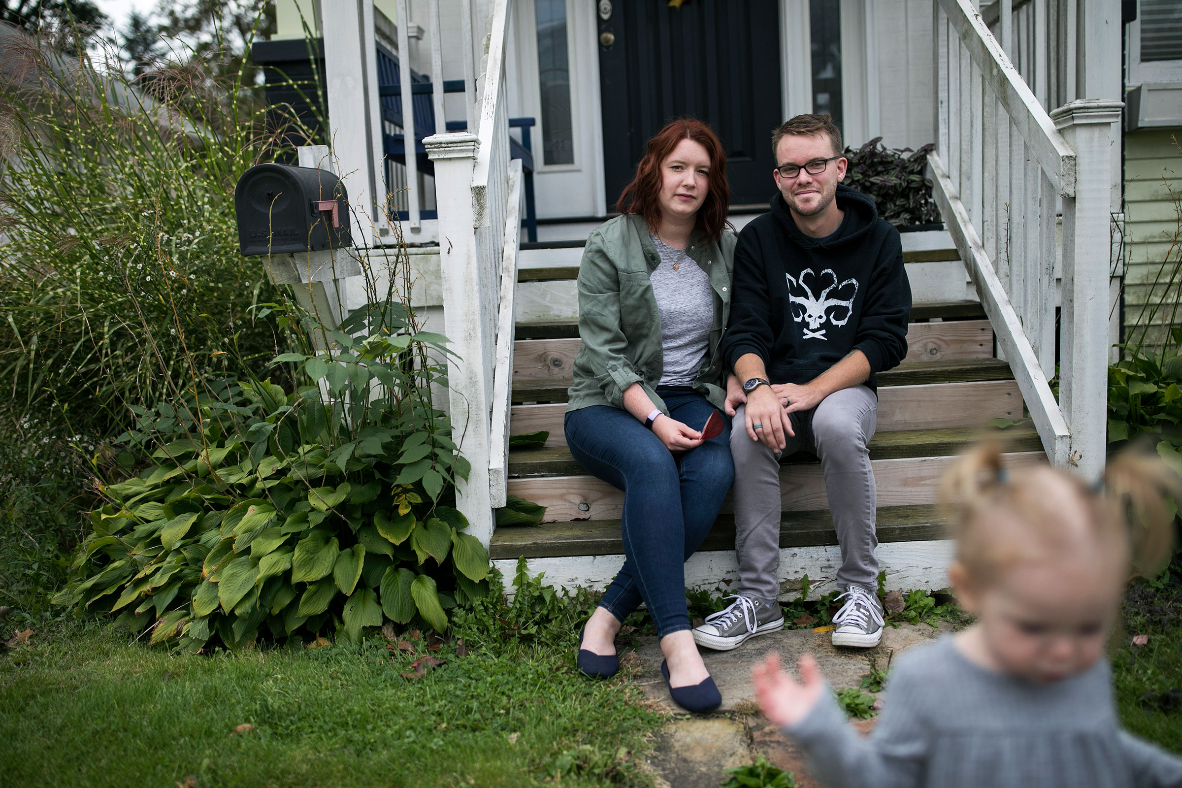 Shelby Parker sits outside of her home with her husband Ben and daughter Abby in Cuyahoga Falls, Ohio on Oct. 3. Parker planned to get pregnant this year but is contemplating not trying for a second child at all now due to the coronavirus pandemic. (Maddie McGarvey for TIME)