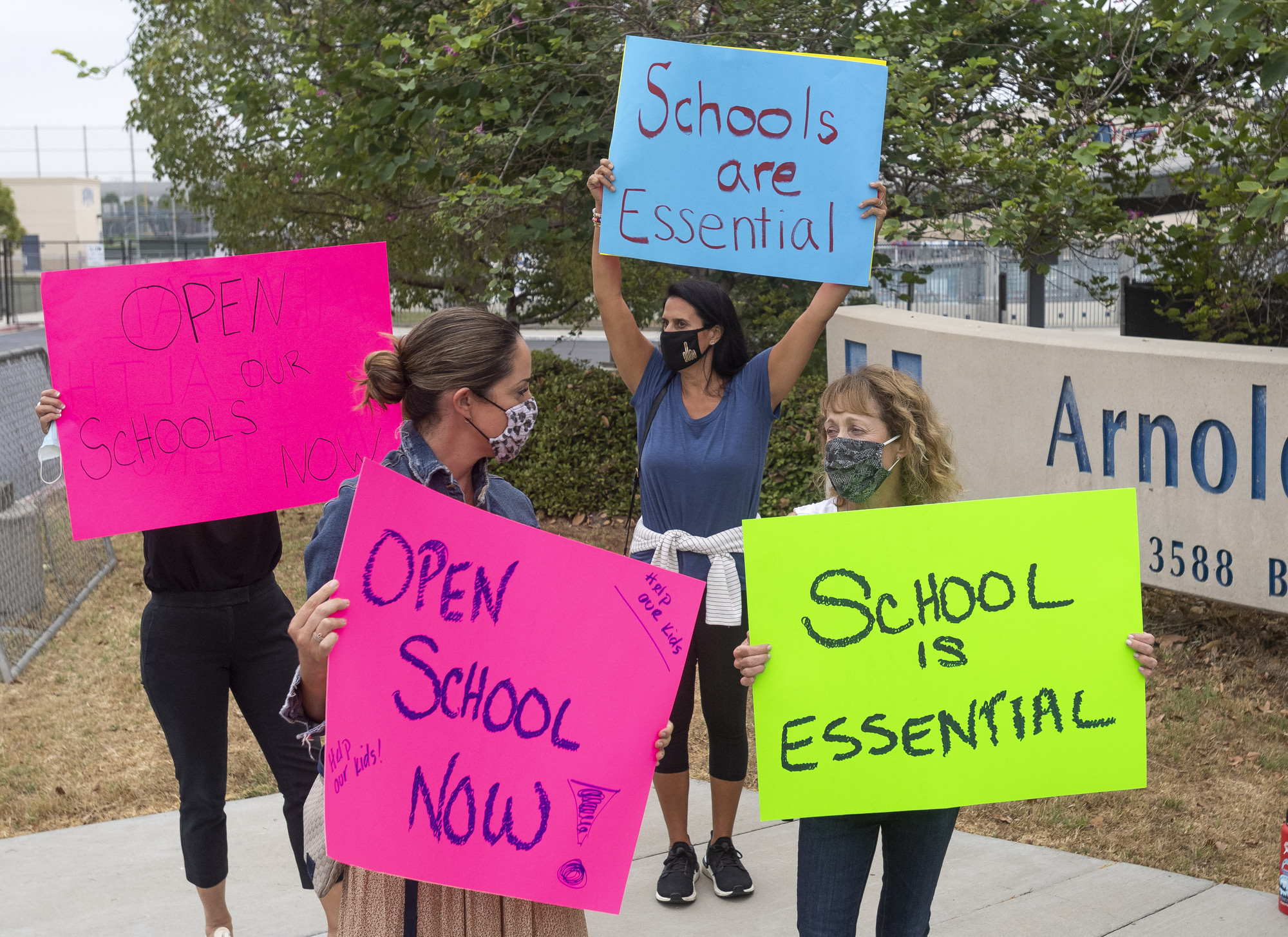 Protesters rally for schools to be reopened for full, in-person instruction outside Beckman High School in Irvine, Calif., on Sept. 8, 2020. (Paul Bersebach—Orange County Register/Getty Images)