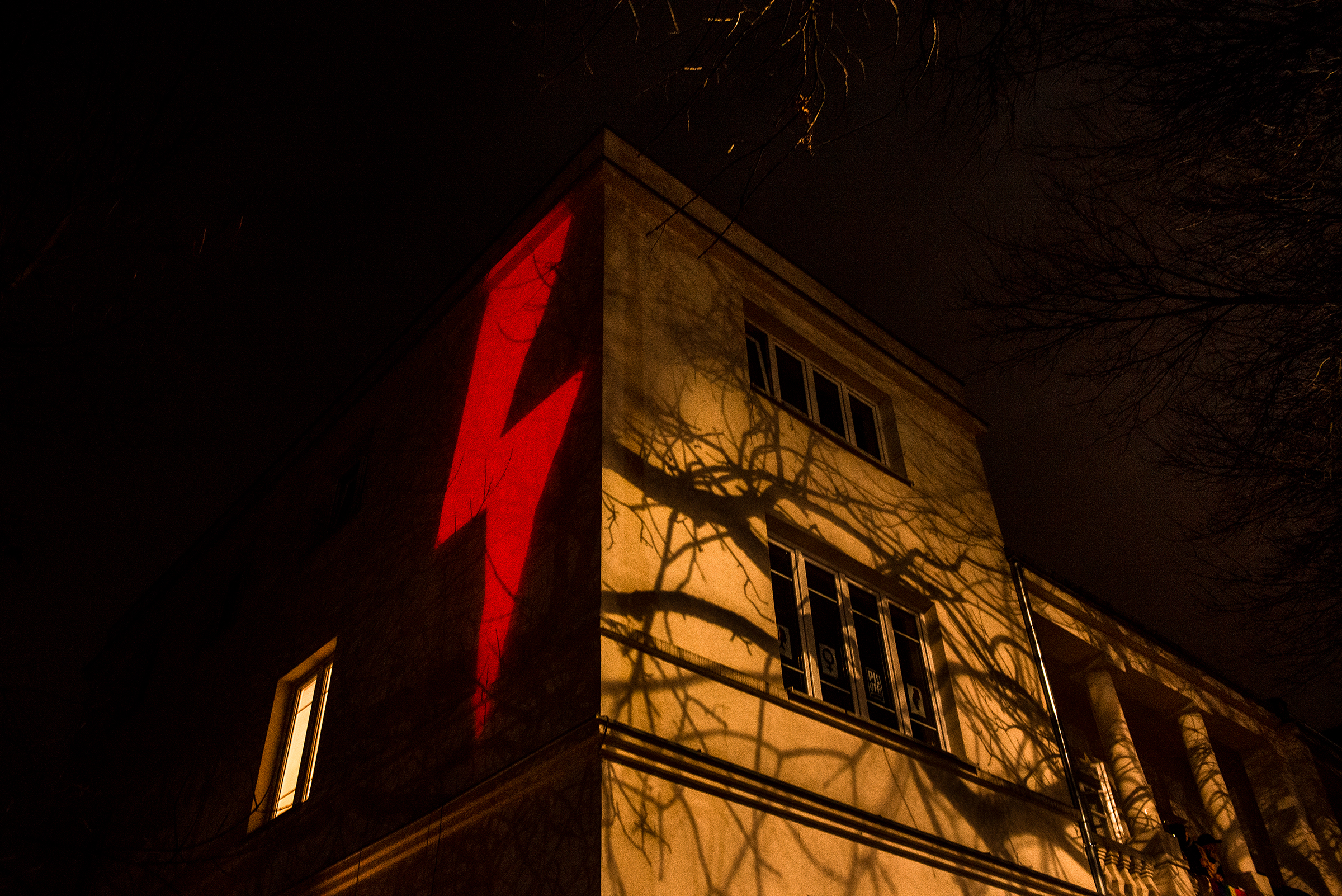 A red lightning bolt, the prominent symbol of recent protests against a Polish court's decision to effectively put a complete ban on abortion, is projected against a building in Warsaw on Oct. 30, 2020. (Kasia Strek)
