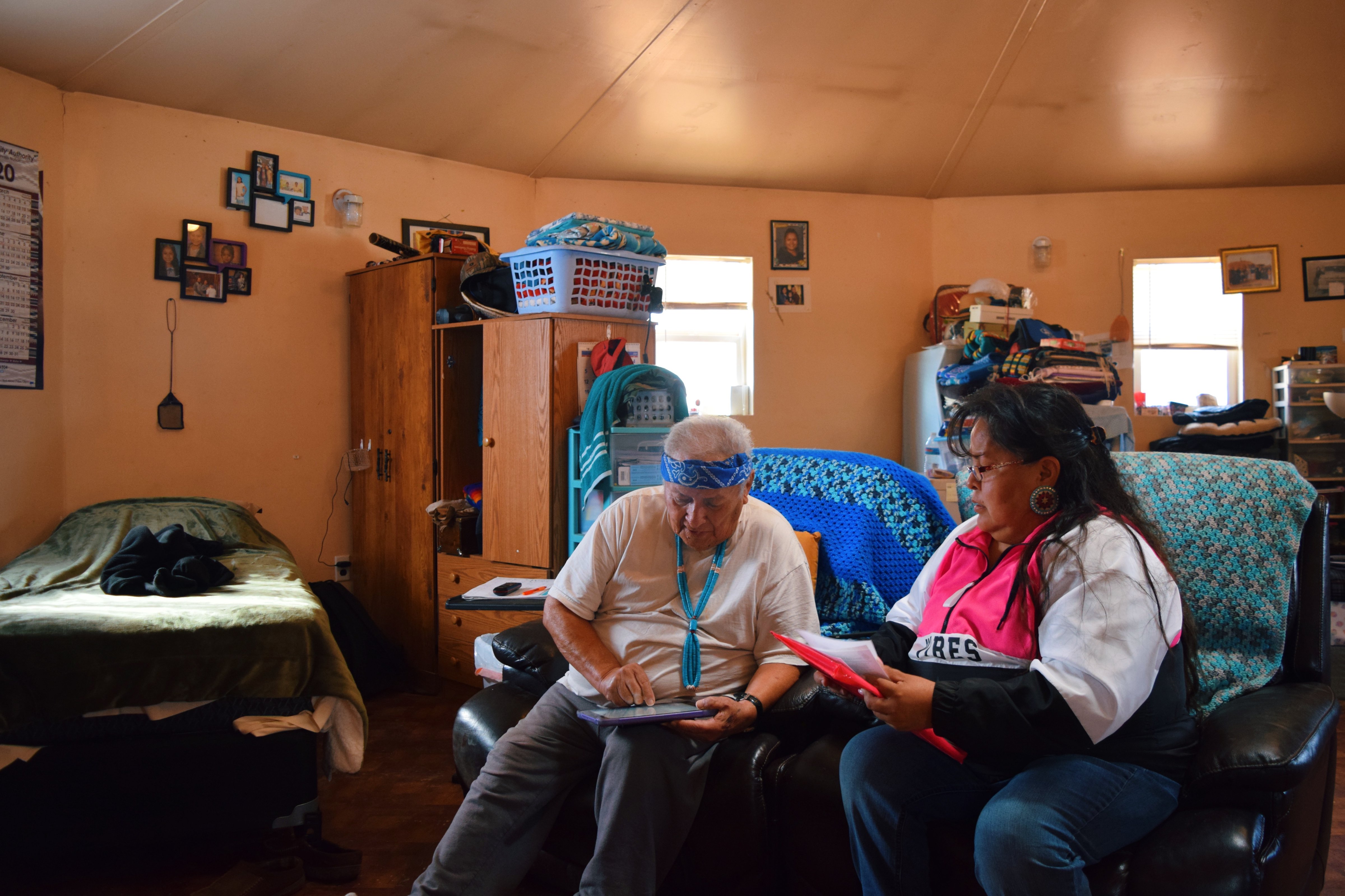 Dalene Redhorse, a field organizer for Rural Utah Project, helps a medicine man update his voter registration and plus code address in Monument Valley, on the Navajo Nation in 2019. (Madeline McGill/Rural Utah Project)