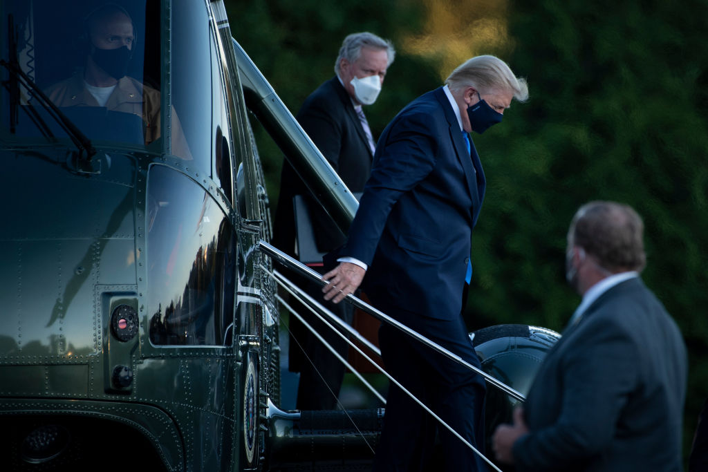White House Chief of Staff Mark Meadows (L) watches as President Donald Trump (C) walks off Marine One while arriving at Walter Reed Medical Center in Bethesda, Md. on Oct. 2, 2020. (Brendan Smialowski—AFP via Getty Images)